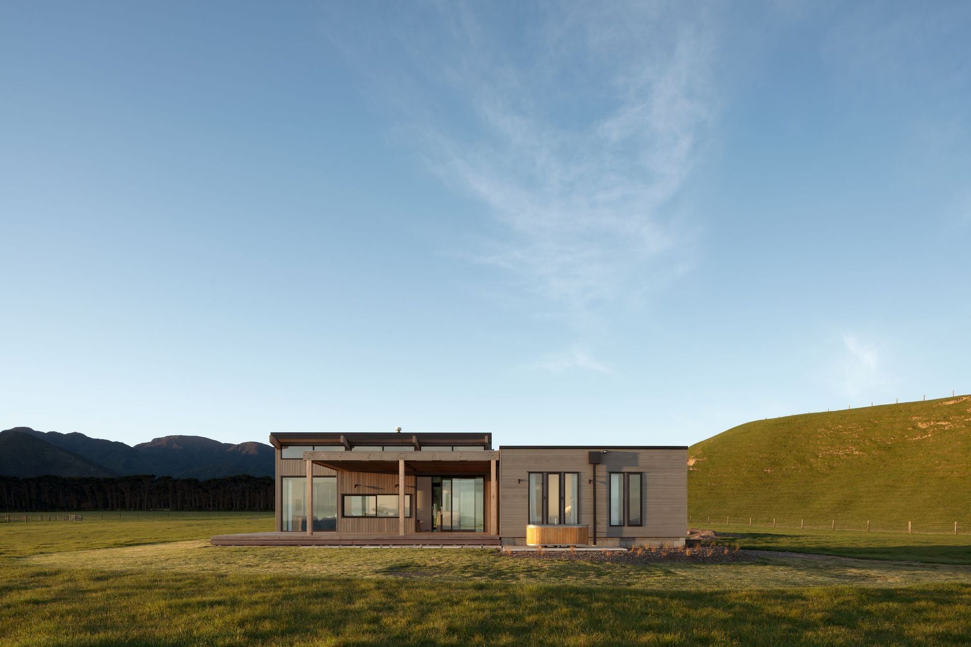 The brief called for a structure that sat within the rural context and that looked like it had been there ‘forever’, says the architect, who designed the bach to look like two farm sheds that have been built up against each other.