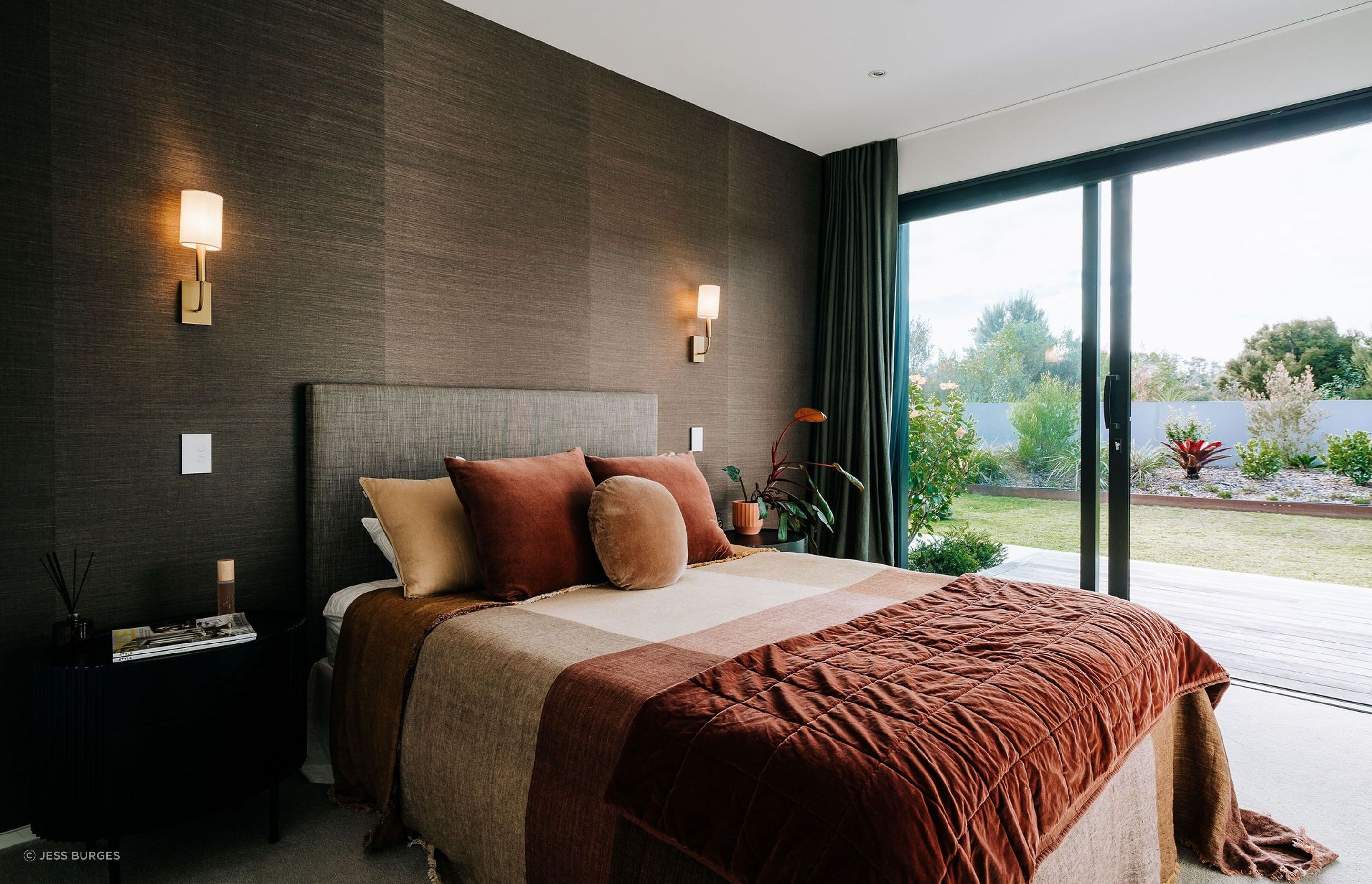 warm-bedroom-wall-lights-bed-throws-red-wallpaper-arcline-architecture.jpg