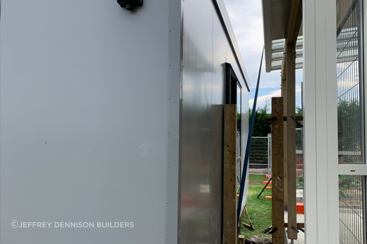 8-Totara-Primary-School-side-view-between-the-new-learning-space-and-existing-classroom-prior-to-the-deck-being-builtLR.jpg