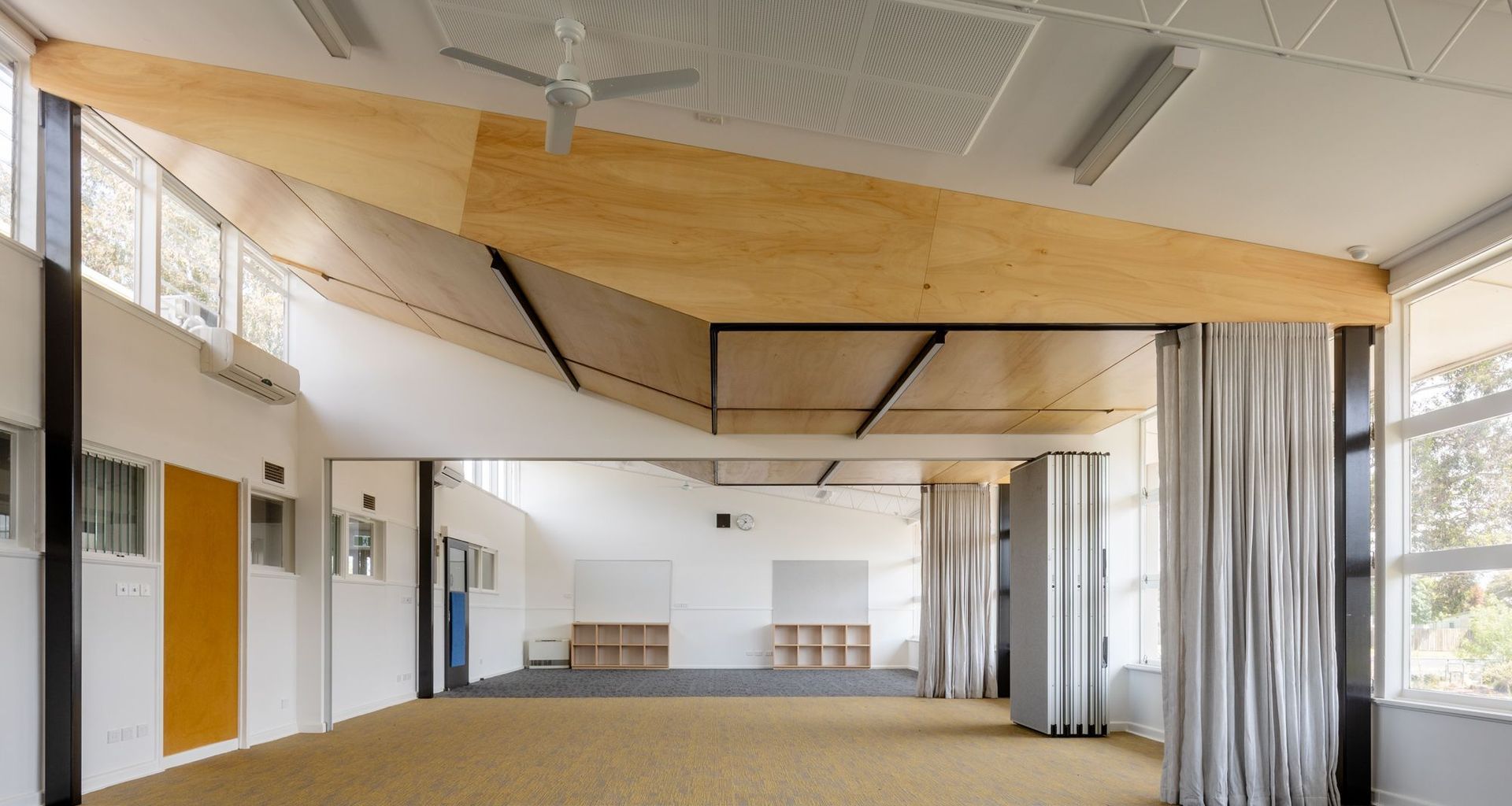 Light wood panelling, integrated lights and provide a bright learning space