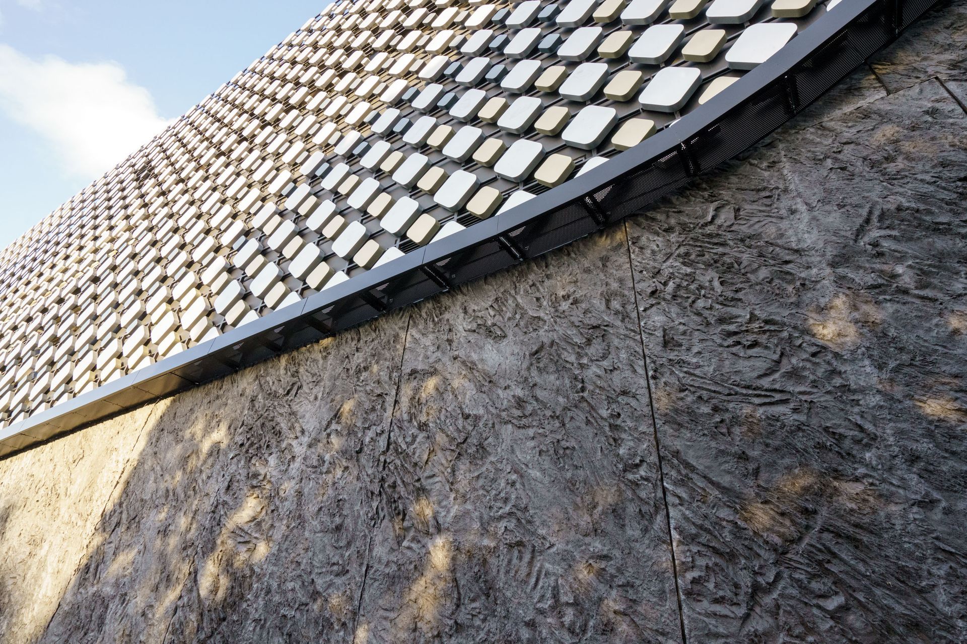 A seven-meter mould with a repeating pattern was created to form the MONARC concrete panels that were tinted with PeterFell SuperBlack to create the desired black granite look.