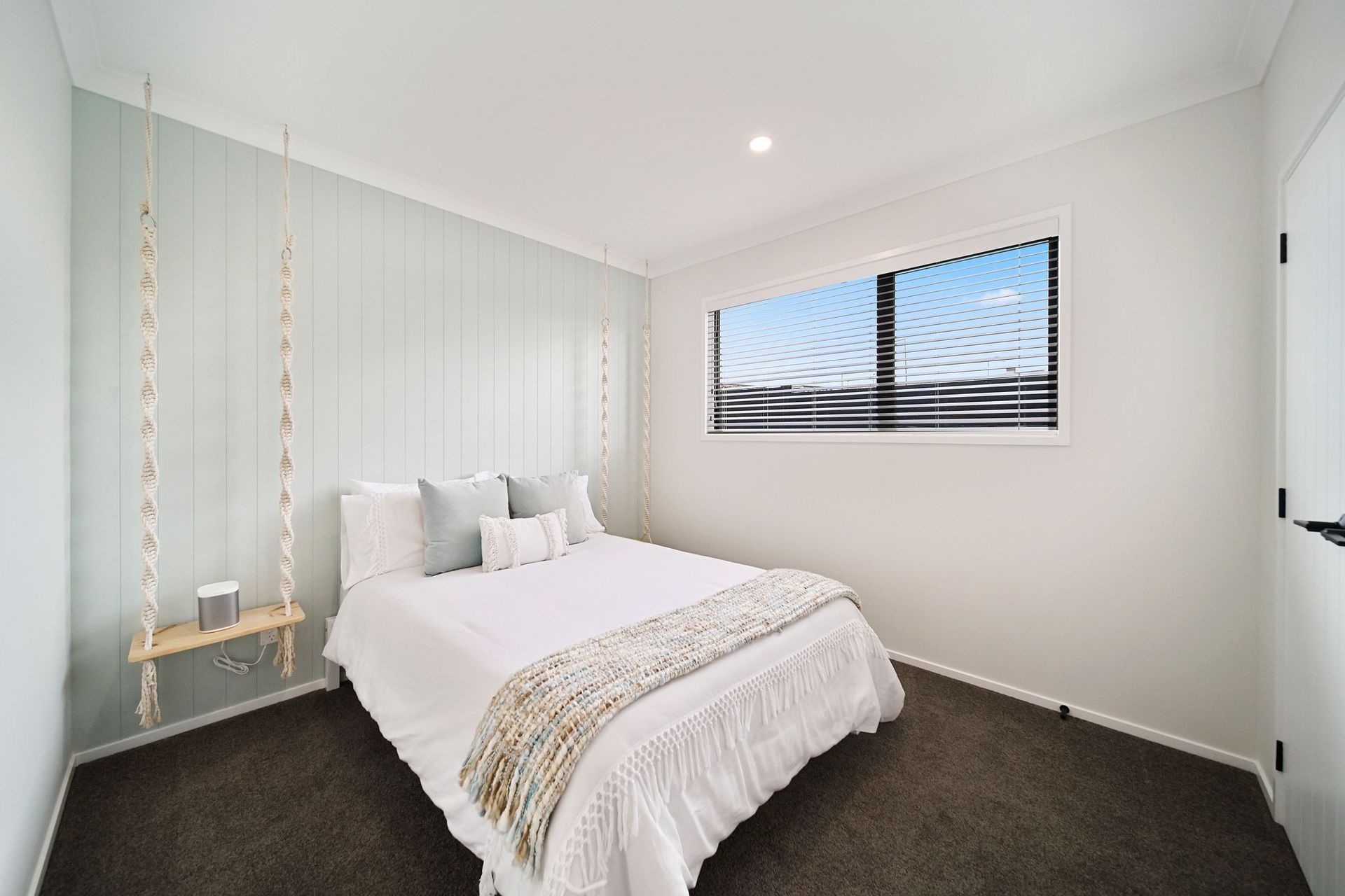 Bedroom with hanging bedside tables