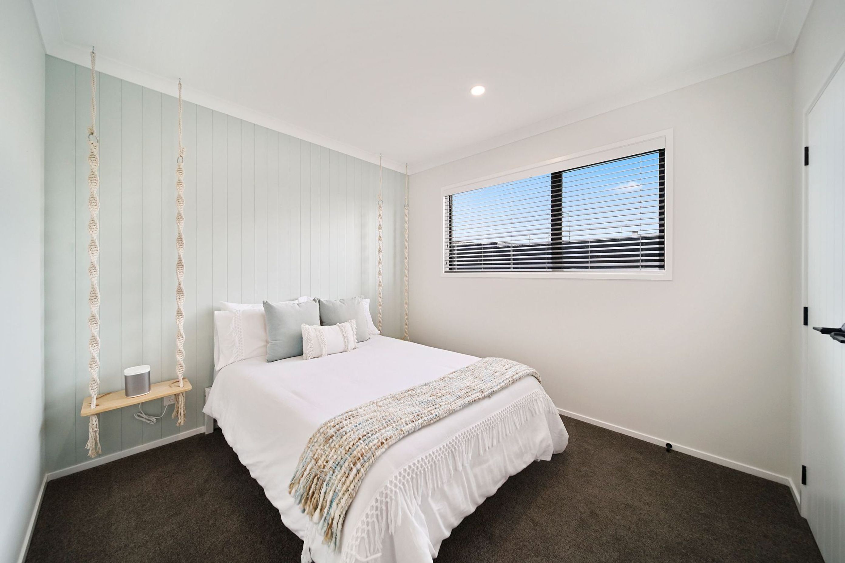 Bedroom with hanging bedside tables