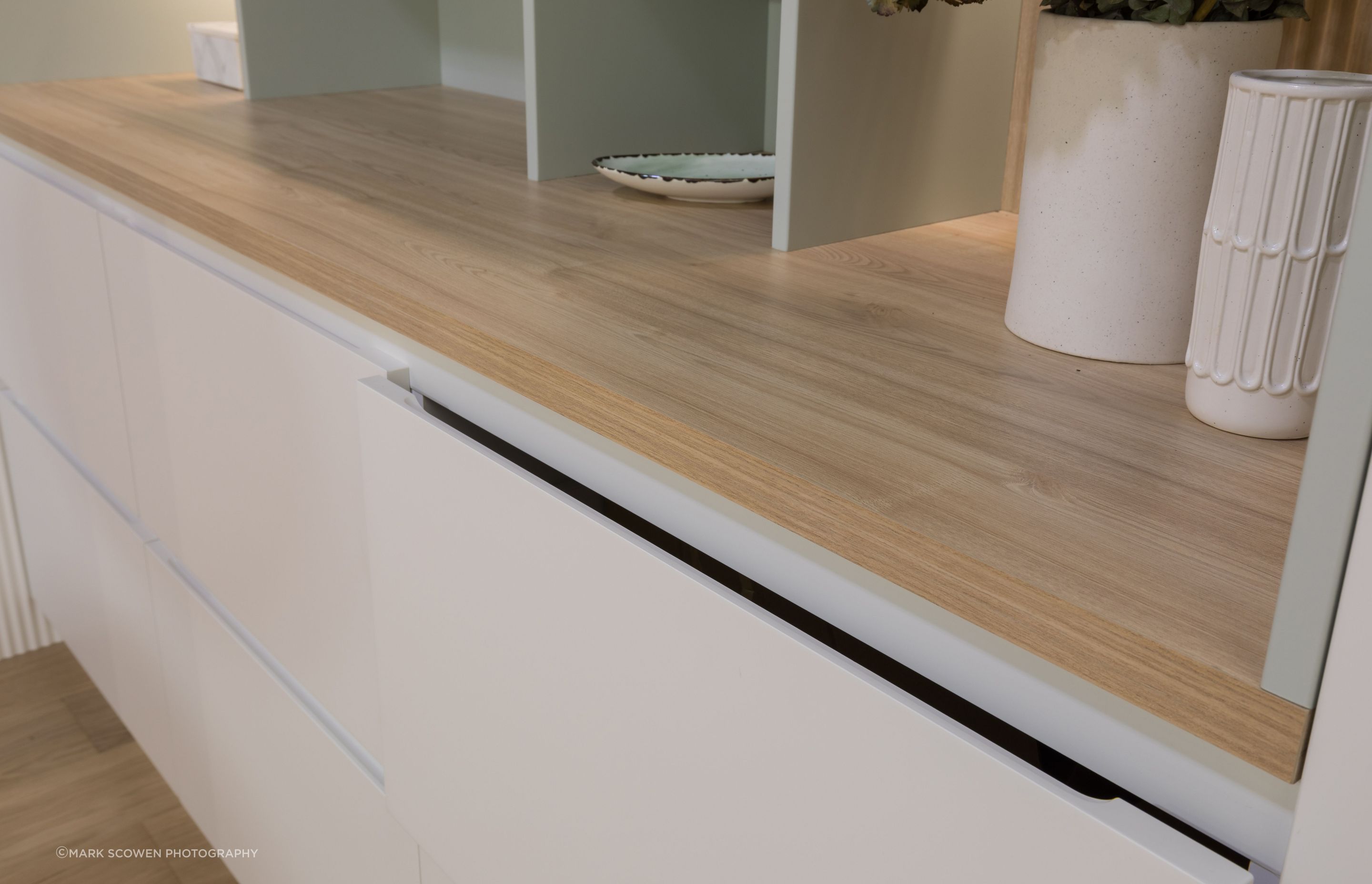 Milan Square with a scallop handle in Limestone - Texture. Shelving top in Ranfurly Oak by Bestwood Melamine. Dezignatek Showroom, Home Ideas Centre Auckland