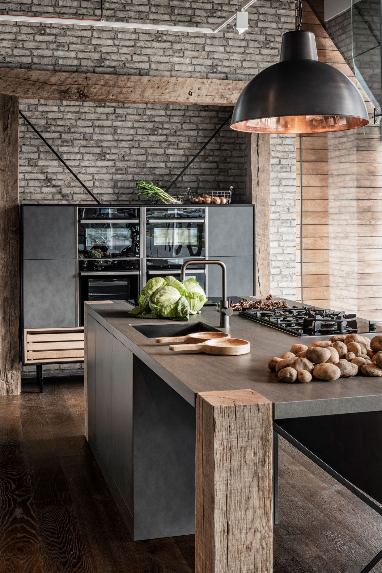 The 200 year old French oak beams are not the only impressive element of this kitchen display by Armstrong Interiors. Shown within this display are NEFF appliances and lighting by ECC