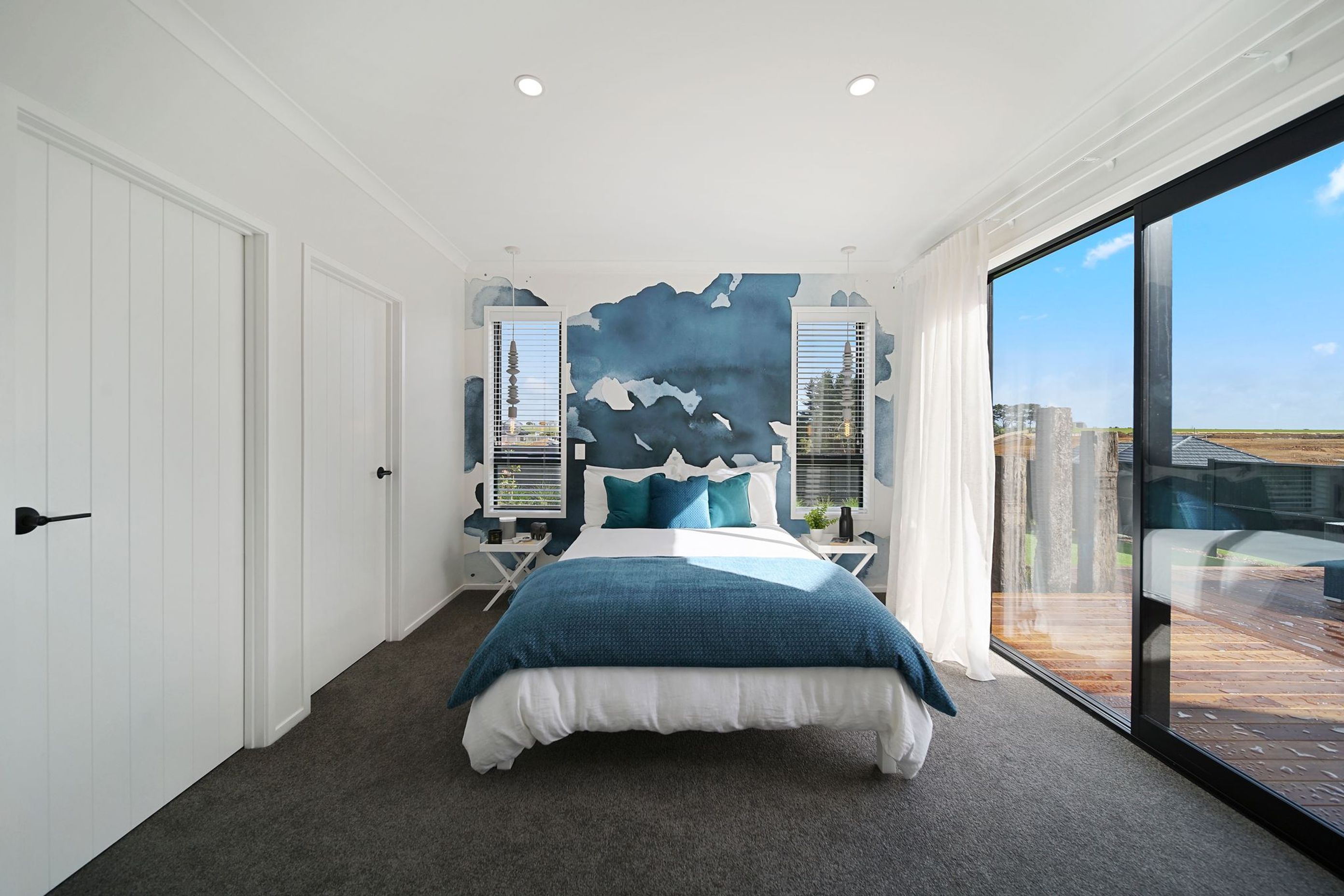 Bedroom with blue water colour feature wall
