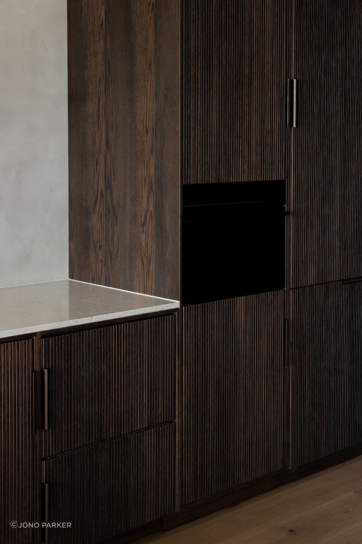 Bespoke fluted-timber cabinetry with intergrated Fisher & Paykel appliances.
