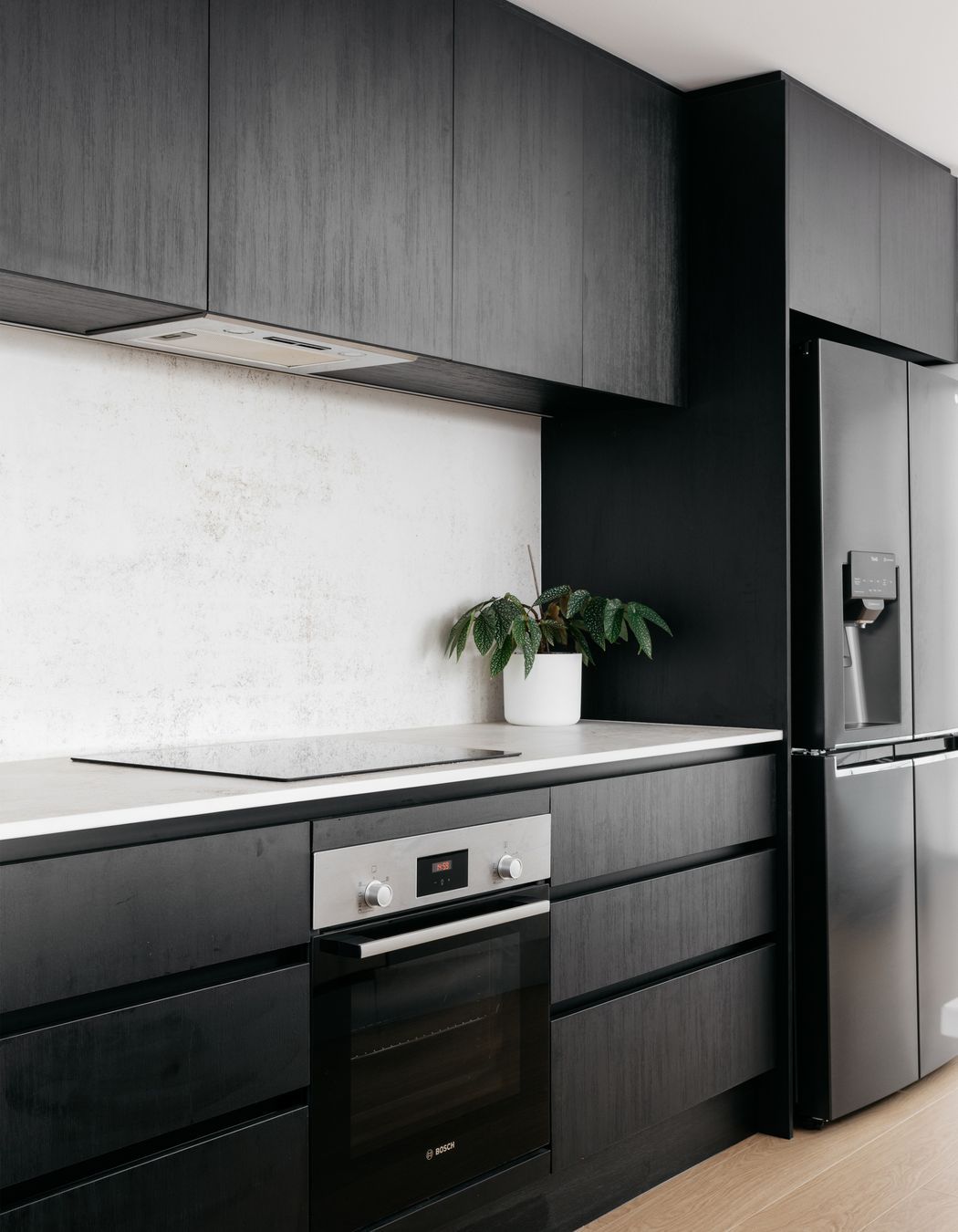 The monochromatic scheme of the kitchen doesn't detract from the ocean view.