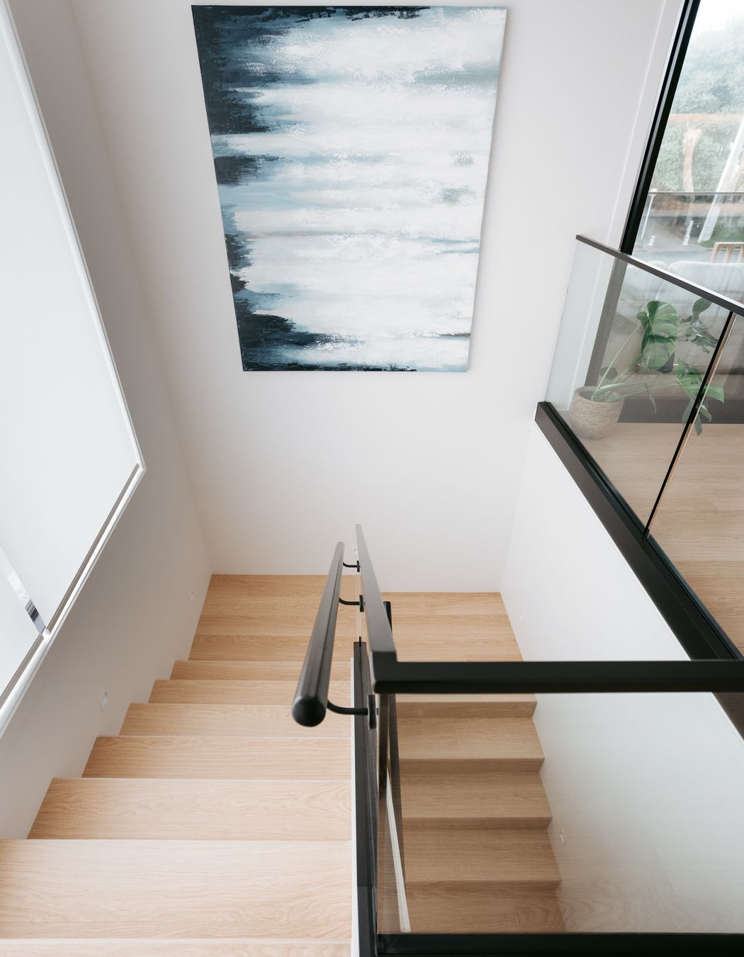 Downstairs includes a garage, separate laundry, main bathroom and two bedrooms.