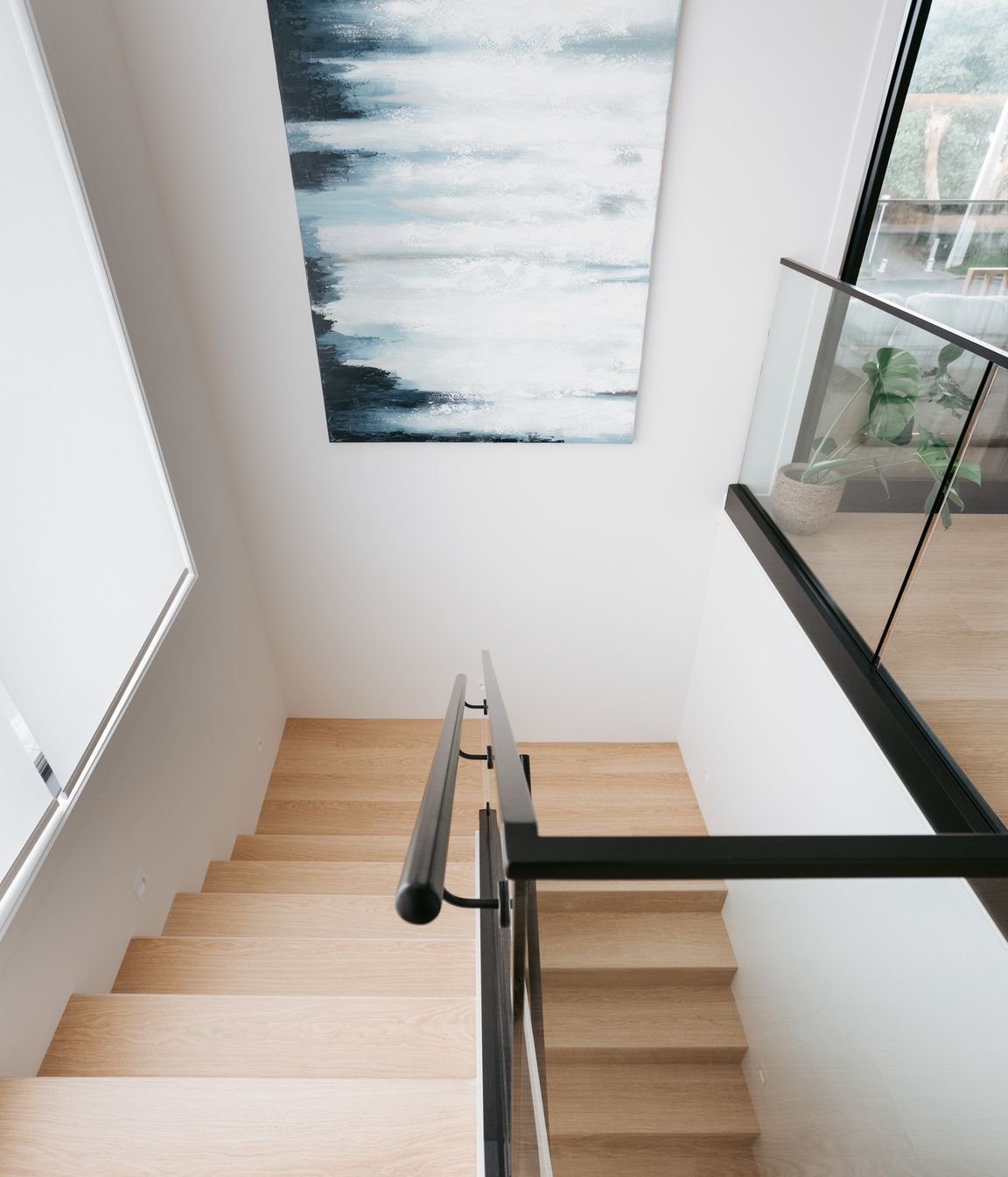 Downstairs includes a garage, separate laundry, main bathroom and two bedrooms.