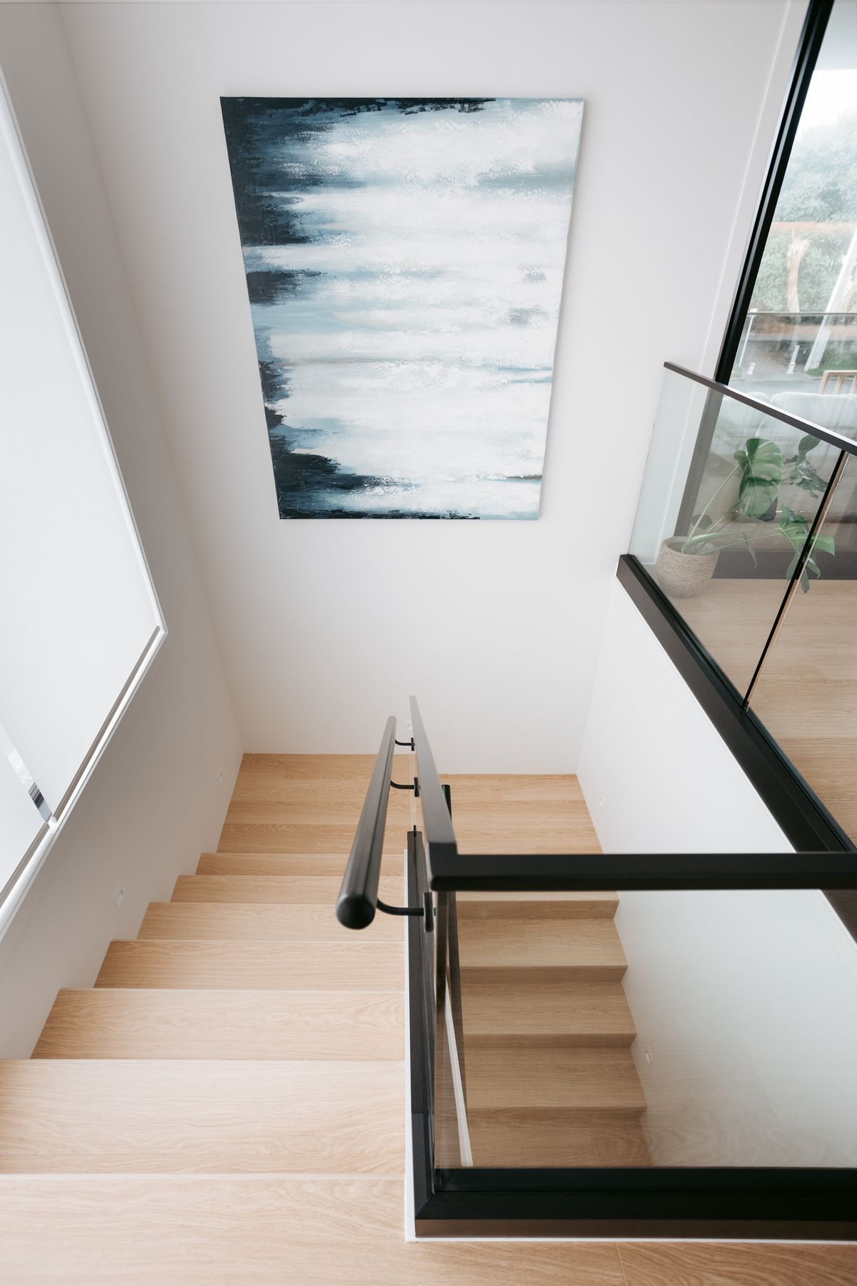 Downstairs includes a garage, separate laundry, main bathroom and two bedrooms.