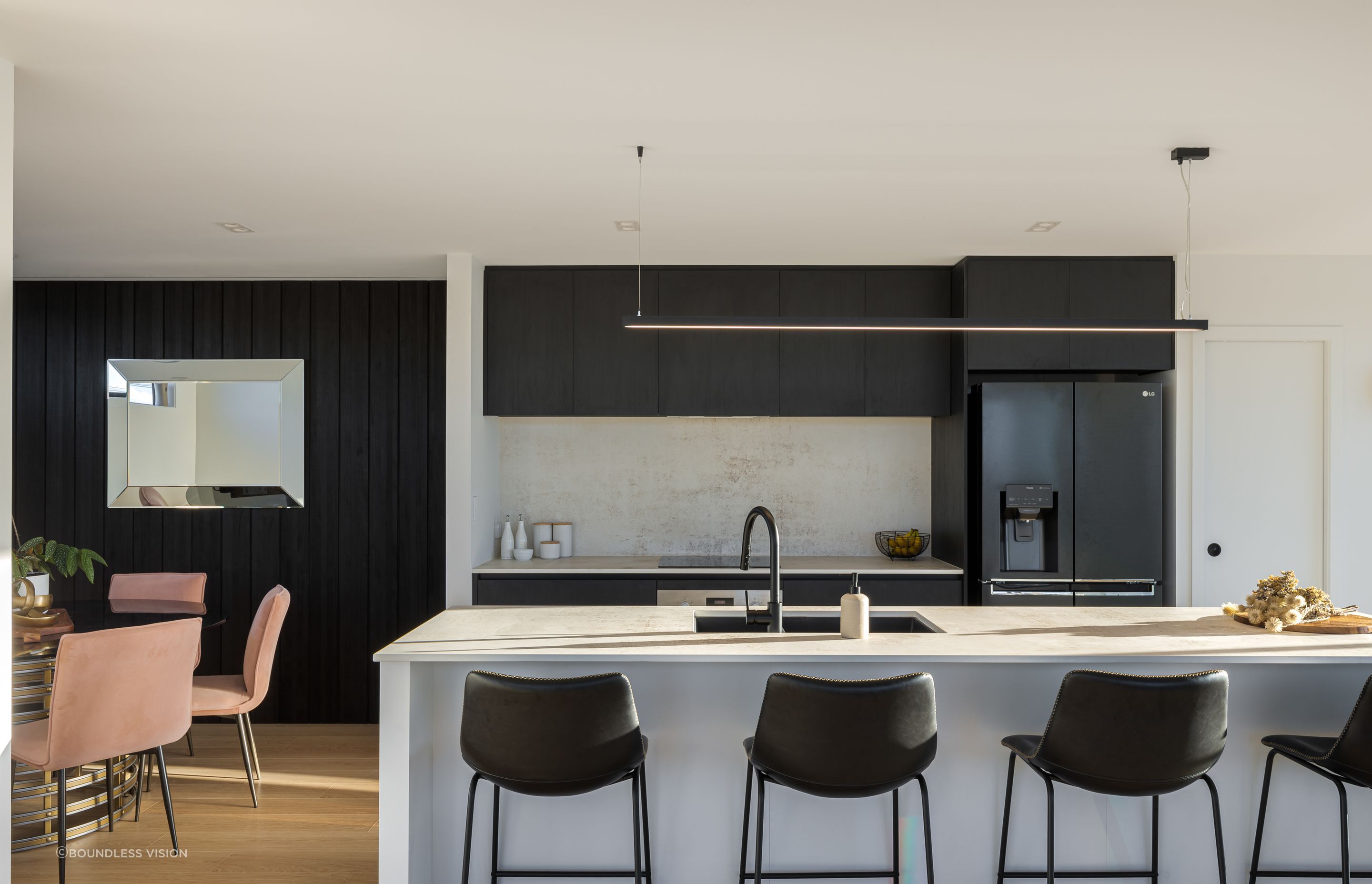 The simplistic palette of the kitchen references the exterior materiality.