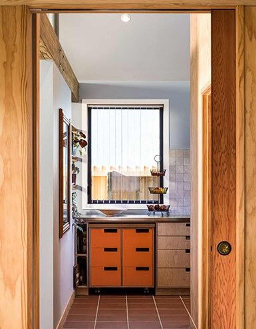 Durable materials—such as the terracotta tiles used in the kitchen—add to the longevity of the overall design scheme.