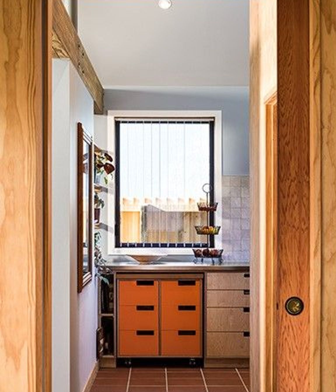Durable materials—such as the terracotta tiles used in the kitchen—add to the longevity of the overall design scheme.