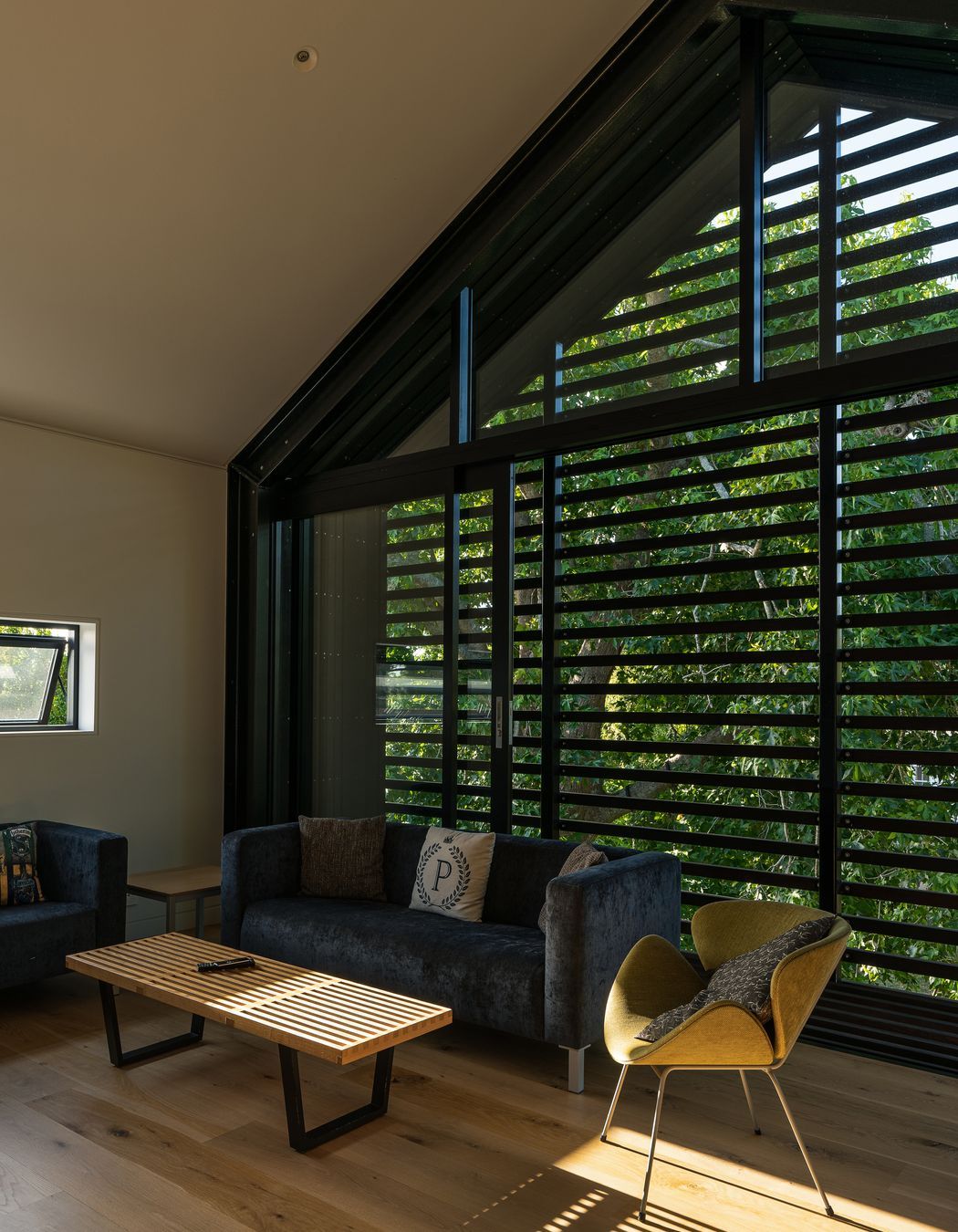 The upstairs living room is very useful with teenage children. “The kids tend to use it when they have friends over. In the summertime the large sliding windows can be left open to ventilate the house. We can leave it open without any security issues because it has the slats across it, which also double as sun control.”