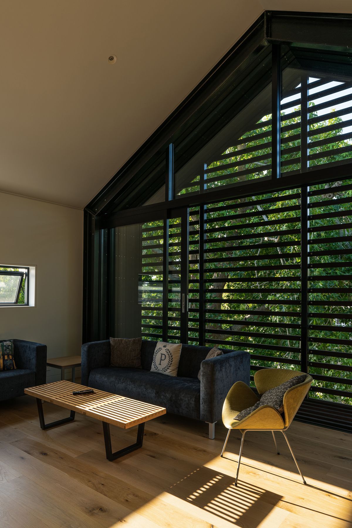 The upstairs living room is very useful with teenage children. “The kids tend to use it when they have friends over. In the summertime the large sliding windows can be left open to ventilate the house. We can leave it open without any security issues because it has the slats across it, which also double as sun control.”