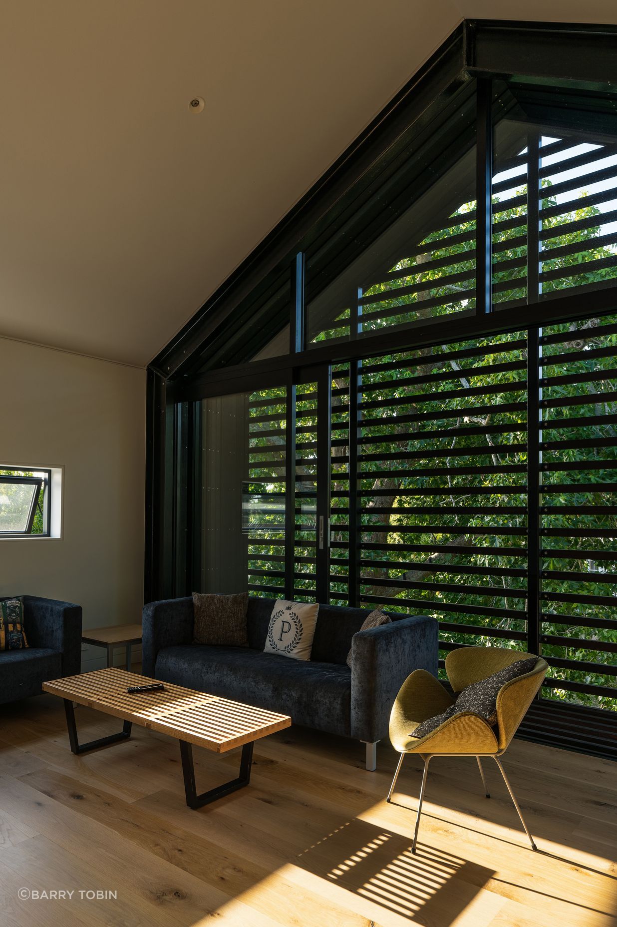 The upstairs living room is very useful with teenage children. “The kids tend to use it when they have friends over. In the summertime the large sliding windows can be left open to ventilate the house. We can leave it open without any security issues because it has the slats across it, which also double as sun control.”