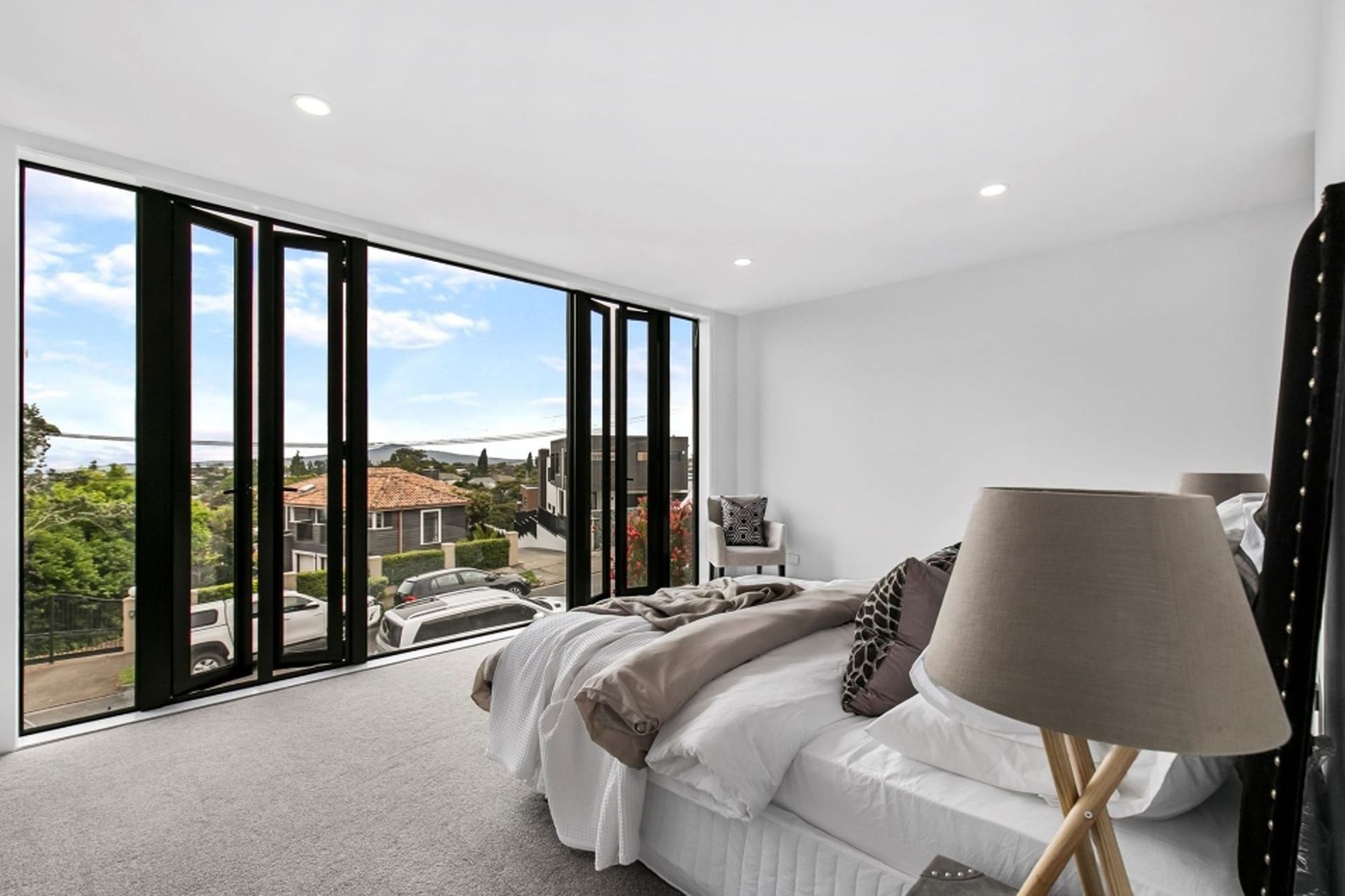 Light, bright and airy, the main bedroom benefits from the floor-to-ceiling glazing and the full-height casement windows.
