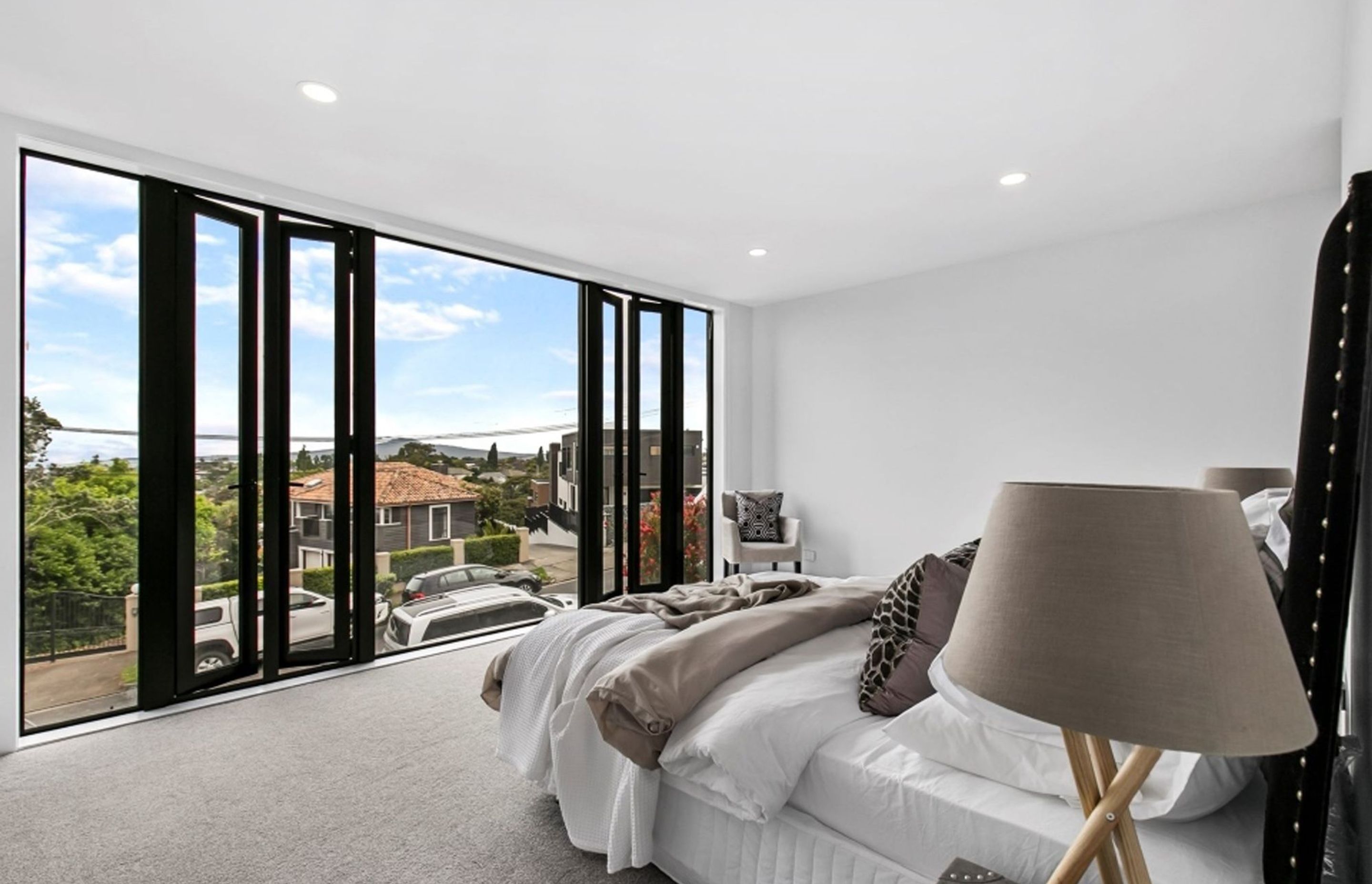 Light, bright and airy, the main bedroom benefits from the floor-to-ceiling glazing and the full-height casement windows.