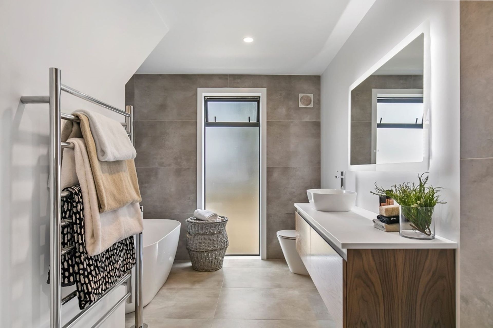 The family bathroom also features a soft palette of natural hues ofset with crisp white and polished chrome.