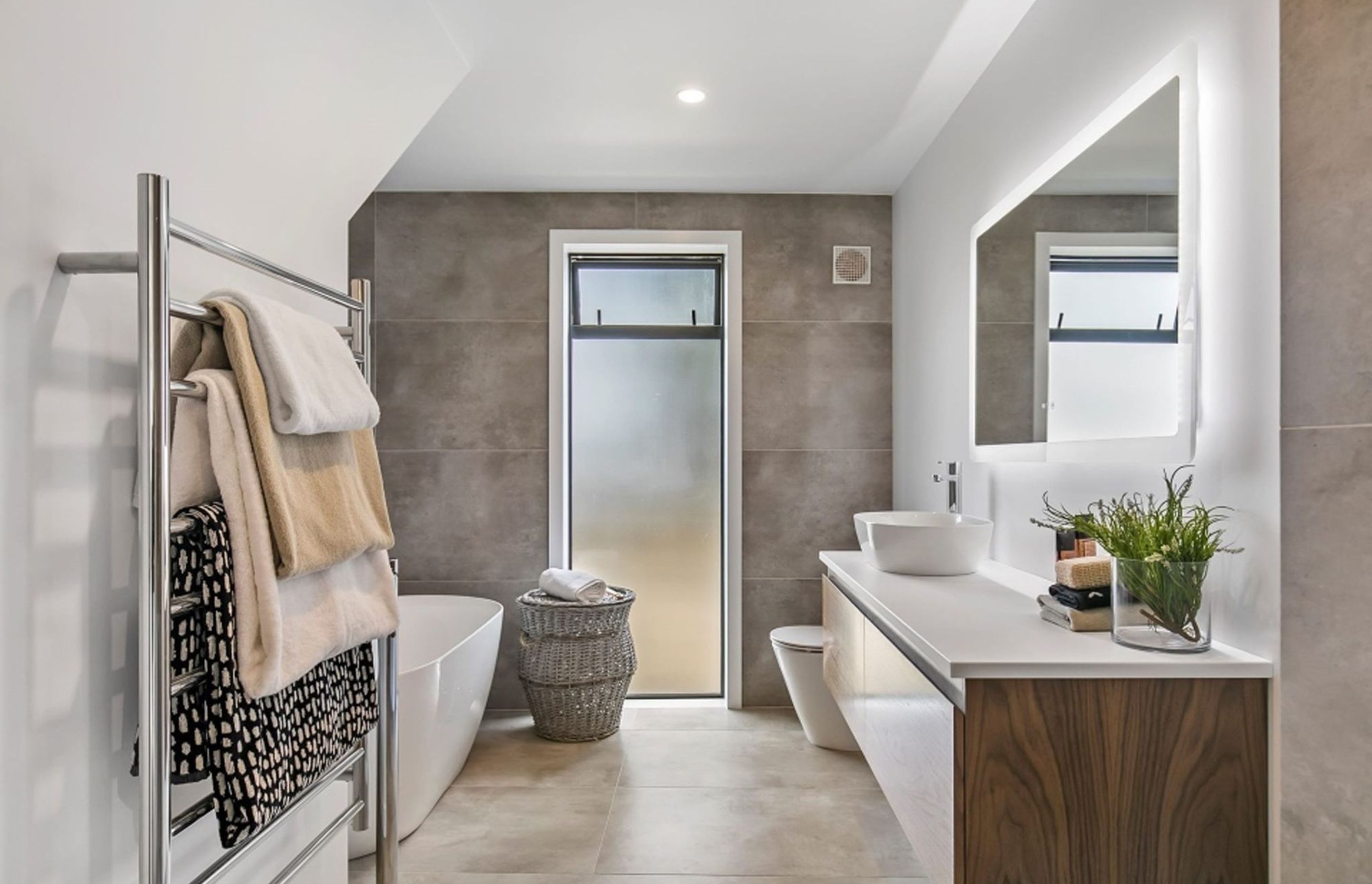 The family bathroom also features a soft palette of natural hues ofset with crisp white and polished chrome.