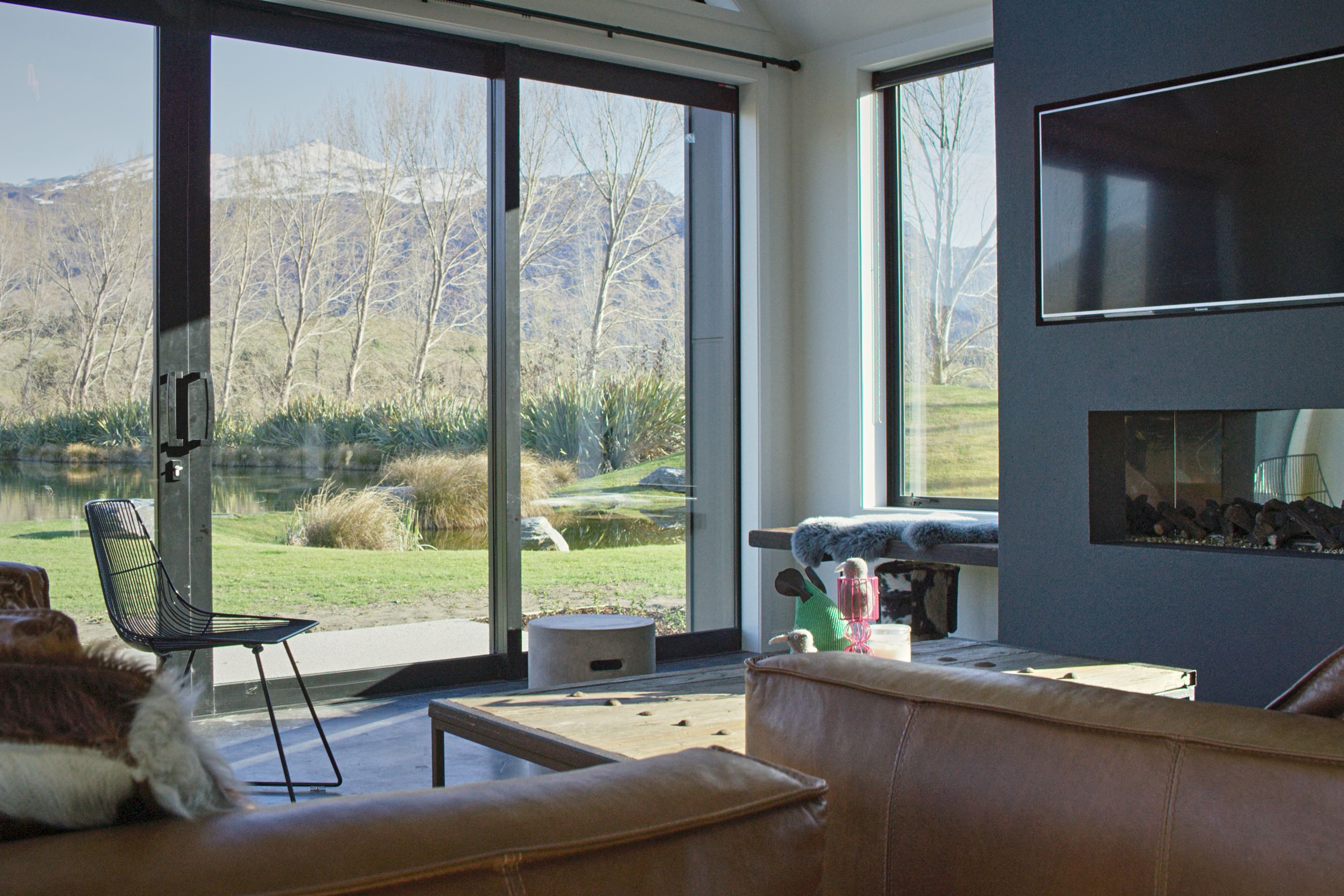 A built-in bench seat next to the fireplace provides a low-key perch from which to take in the view from the side window.