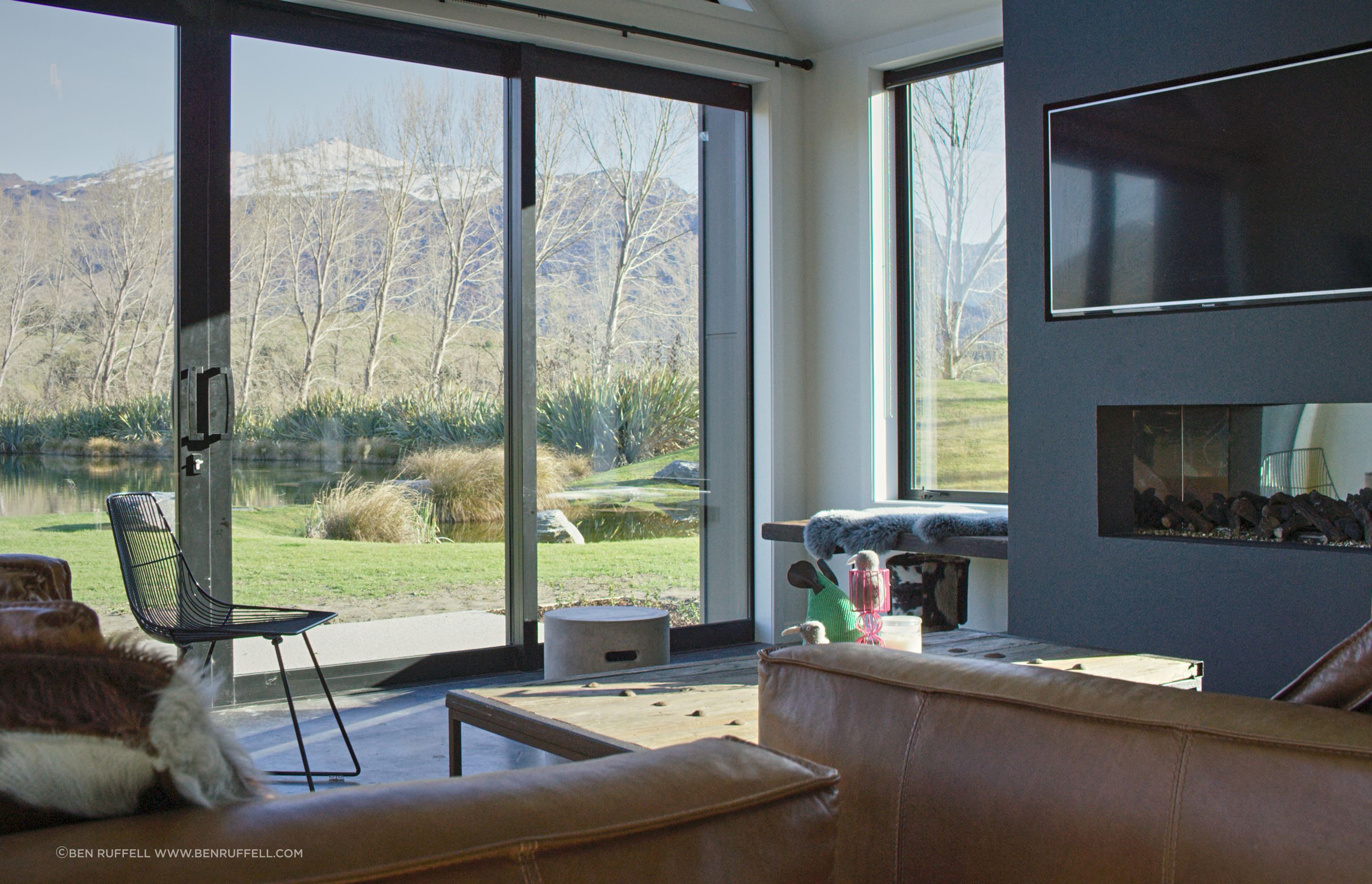 A built-in bench seat next to the fireplace provides a low-key perch from which to take in the view from the side window.