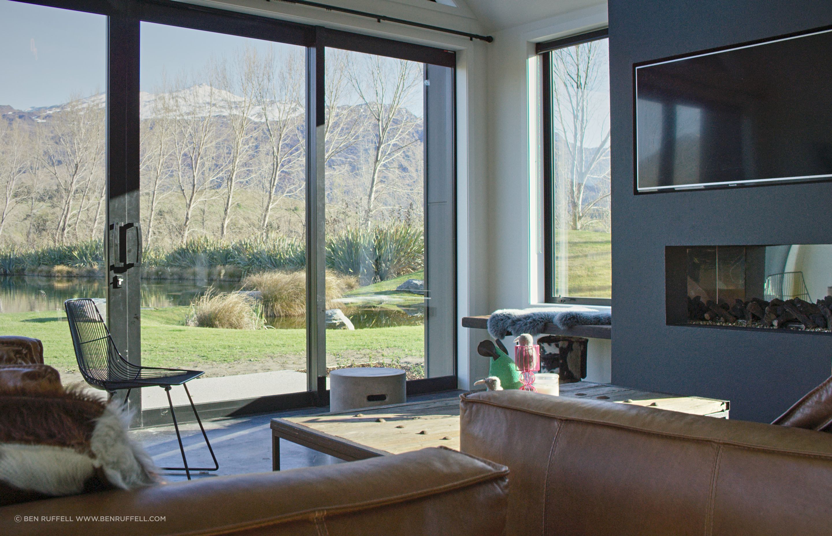 A built-in bench seat next to the fireplace provides a low-key perch from which to take in the view from the side window.
