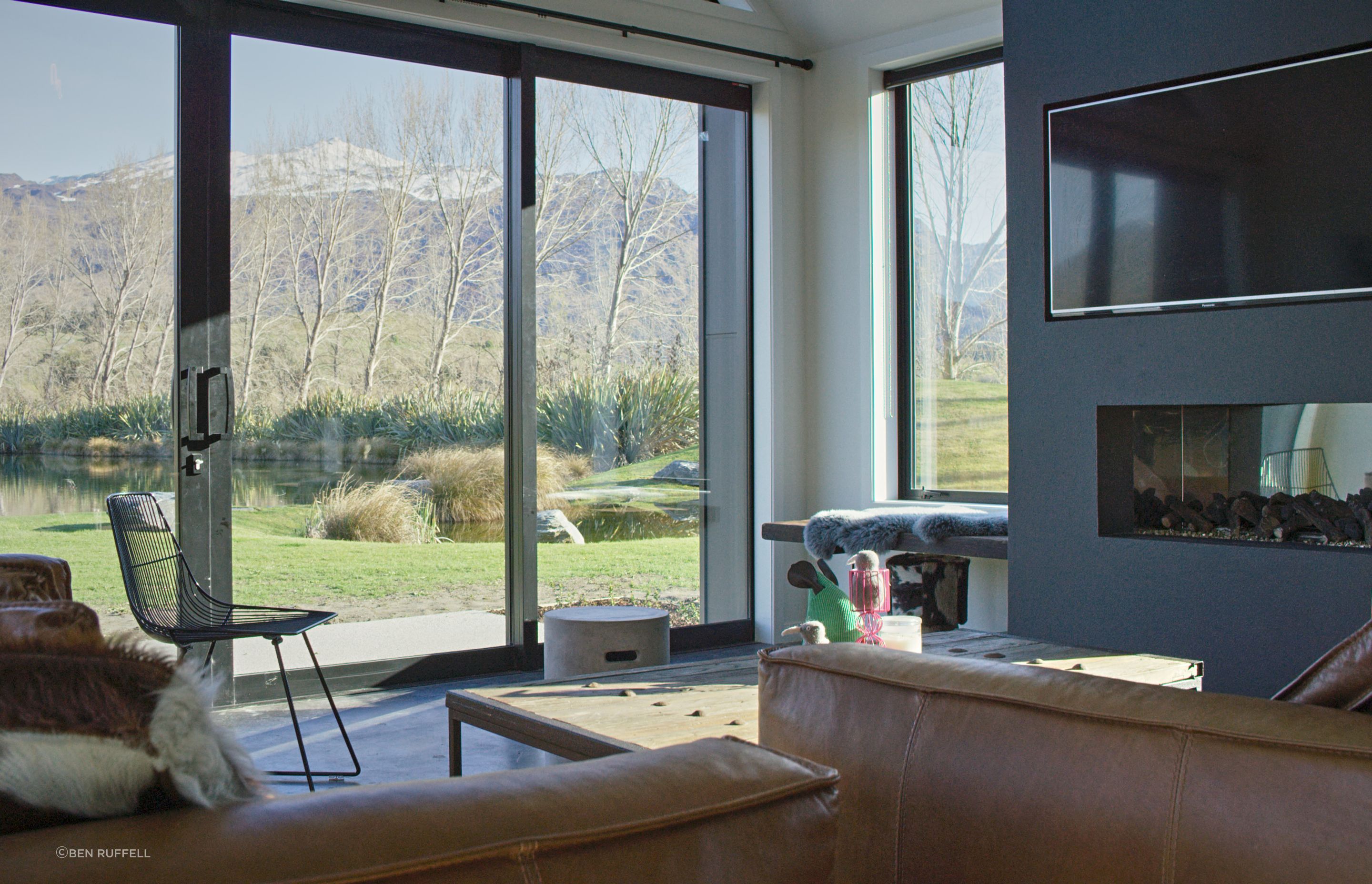 A built-in bench seat next to the fireplace provides a low-key perch from which to take in the view from the side window.