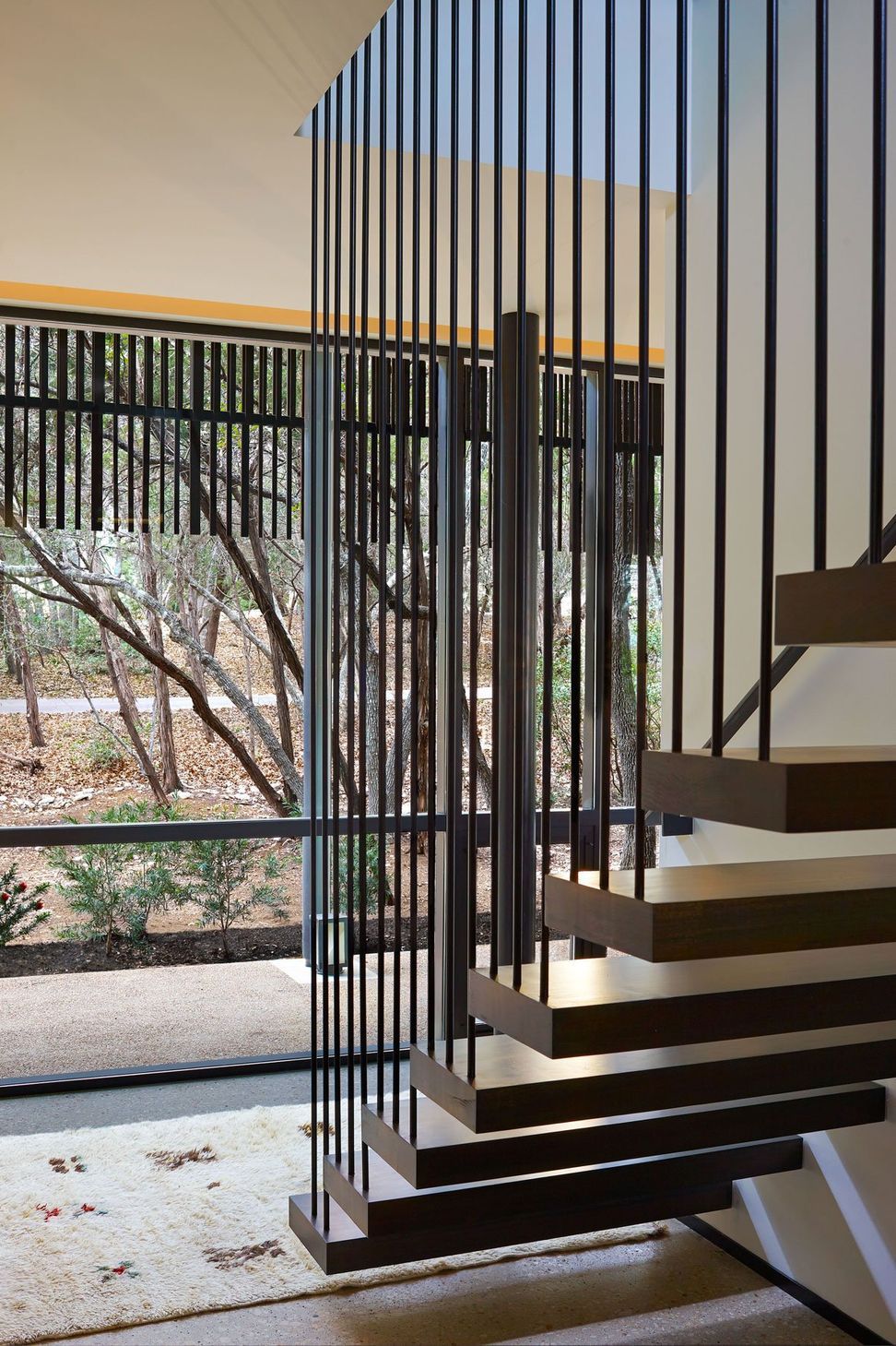 13HouseinTreesCuppettKilpatrickArchitectureandInteriorDesignaustin-tx-modern-staircase-floating-wood-treads-steel-rods.jpg