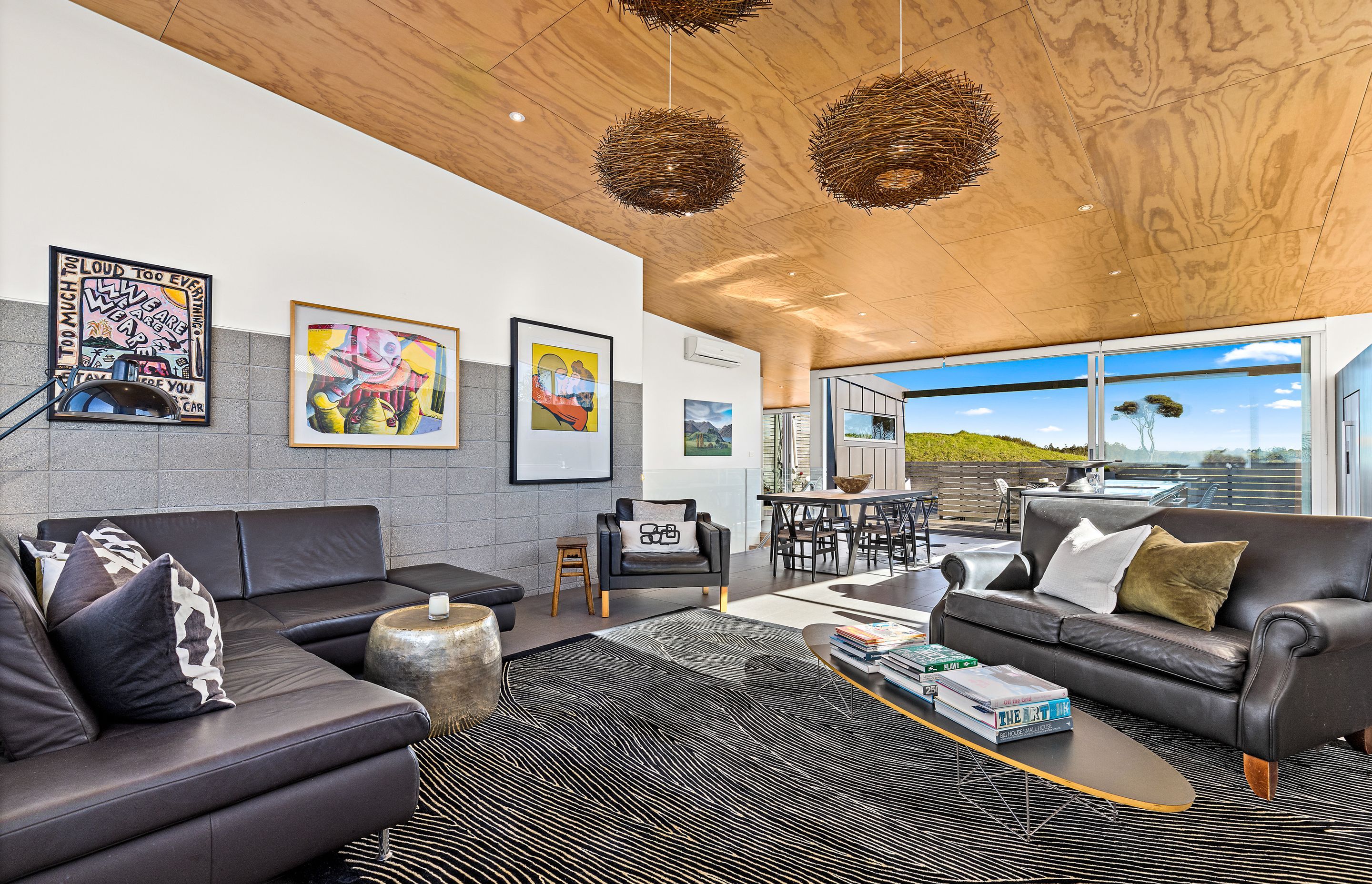 Living Room with Golf Course vista with stack bonded masonry wall feature Photo Credit:Amy Jenkins/Glasshouse Photography
