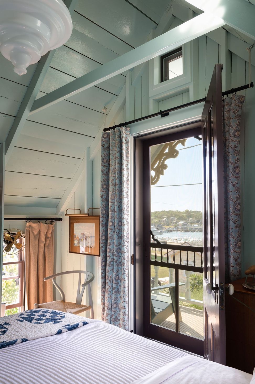 19MarthasVineyardCottageCuppettKilpatrickArchitectureandInteriorDesignvaulted-bedroom-open-door-water-view.jpg