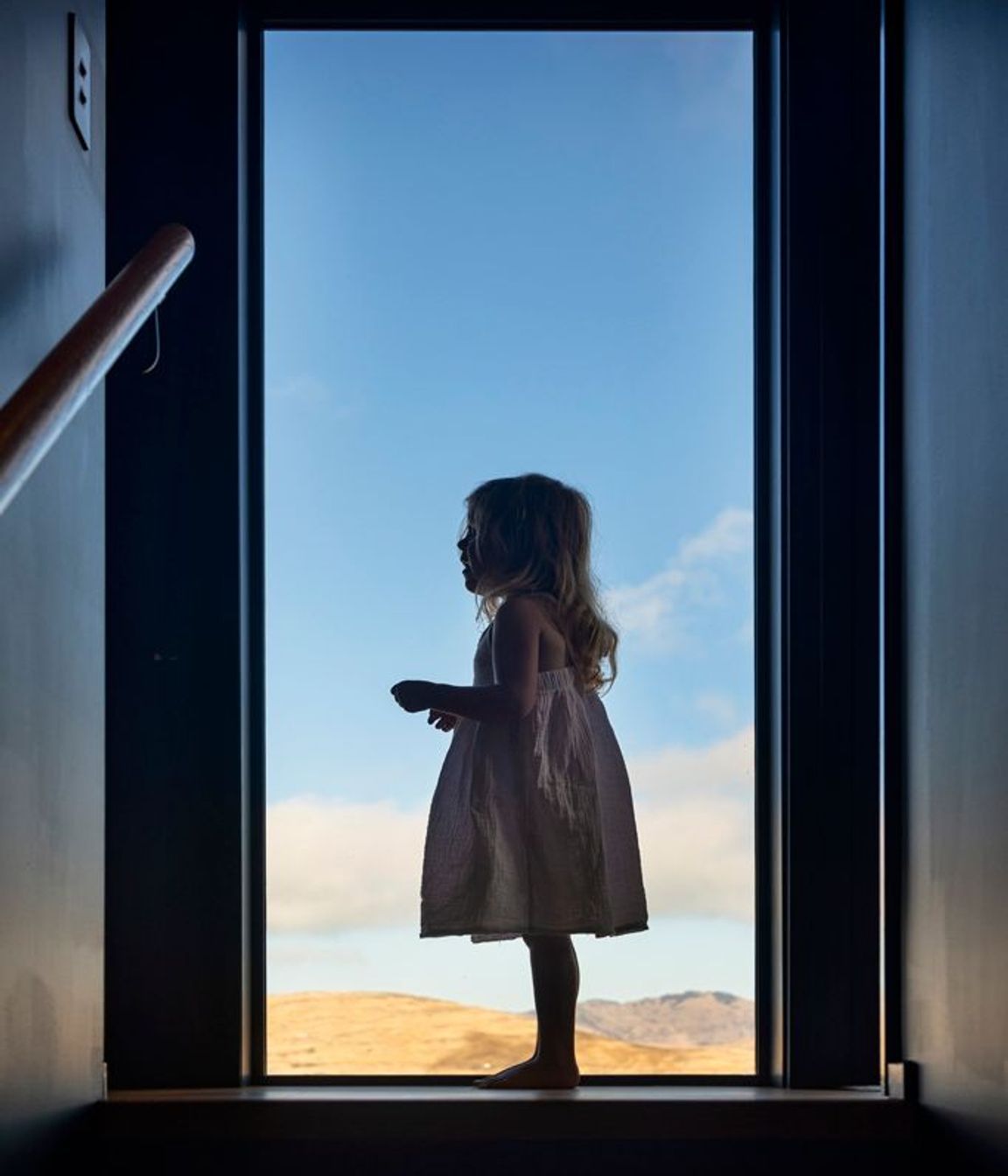 Floor-to-ceiling windows frame the wide-reaching views.