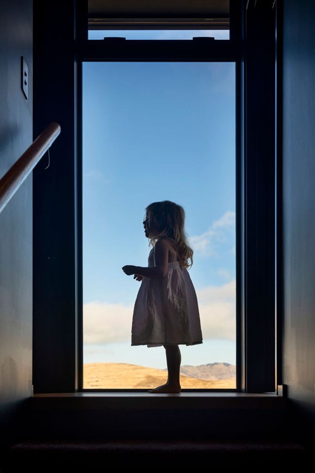 Floor-to-ceiling windows frame the wide-reaching views.
