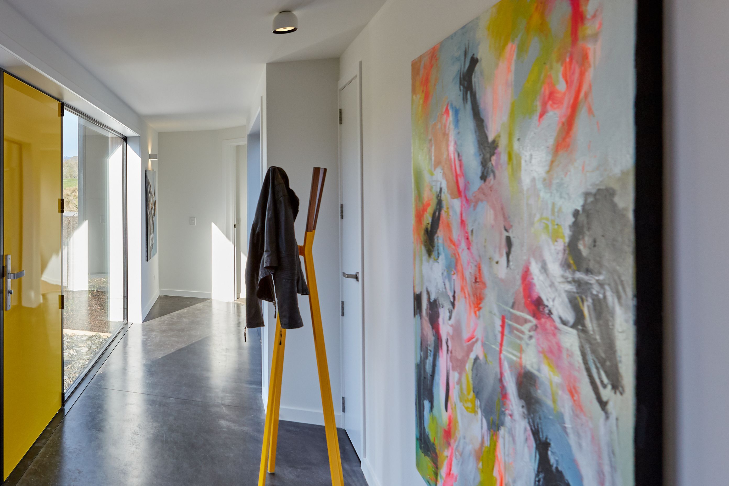 Quirky elements and pops of colour juxtapose the neutral base palette and concrete floors.