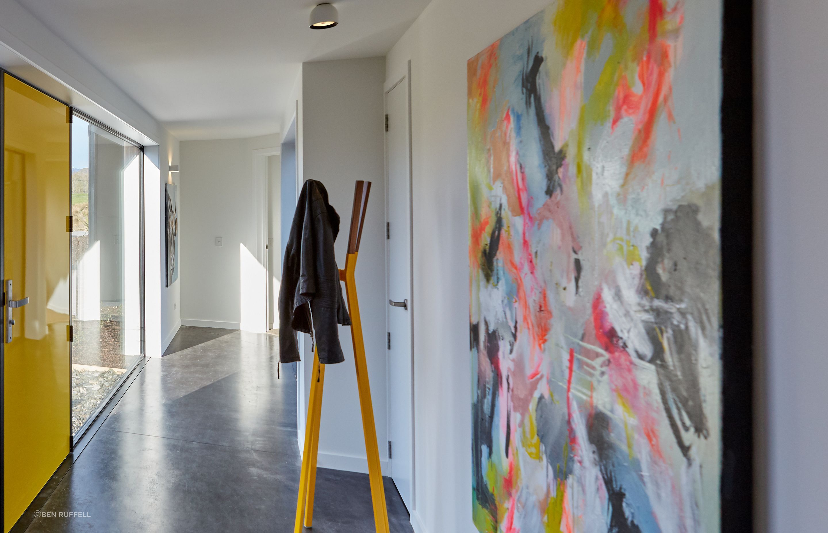 Quirky elements and pops of colour juxtapose the neutral base palette and concrete floors.