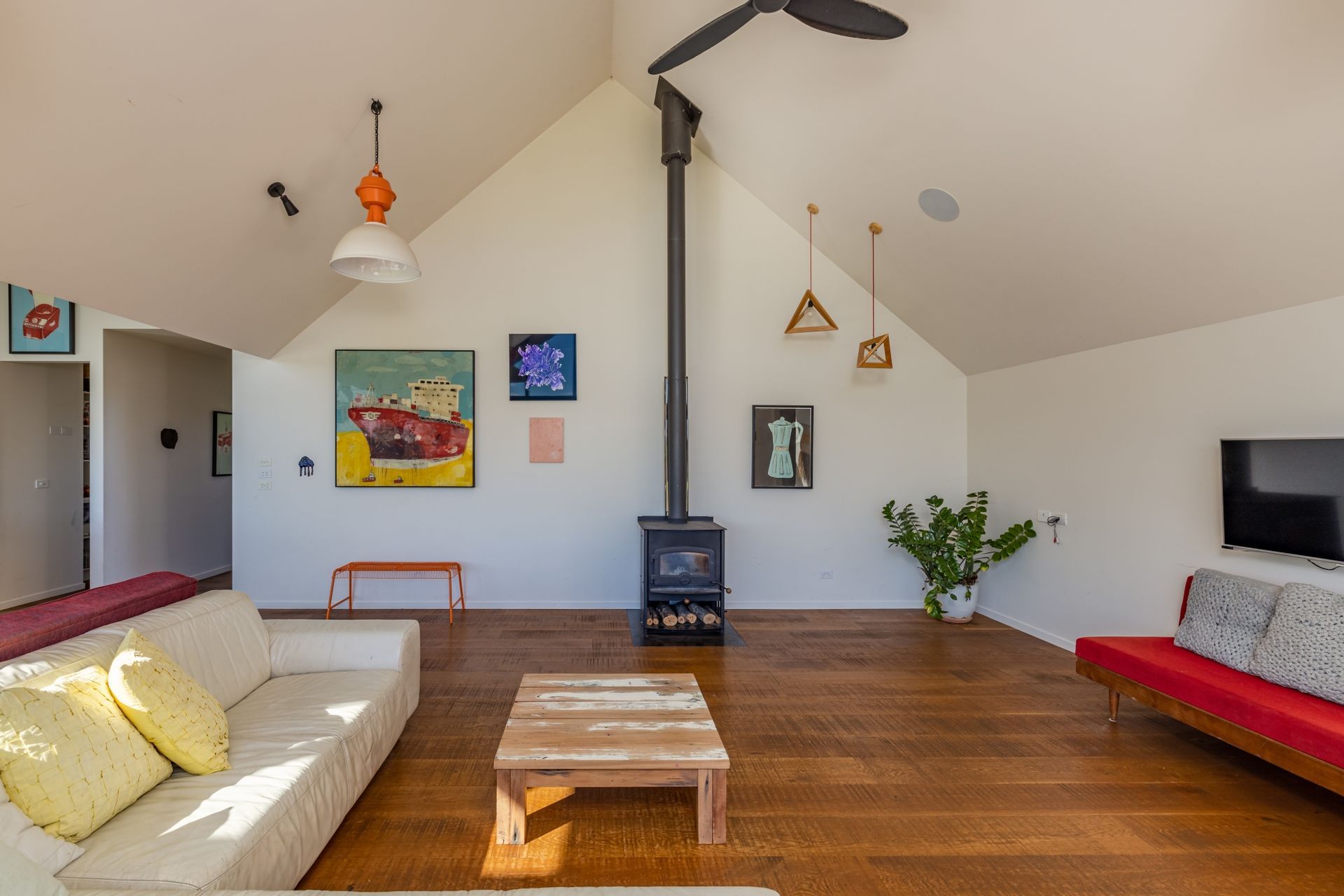 Colourful accents and quirky light fixtures add a touch of vibrancy to the 'farm building' aesthetic.