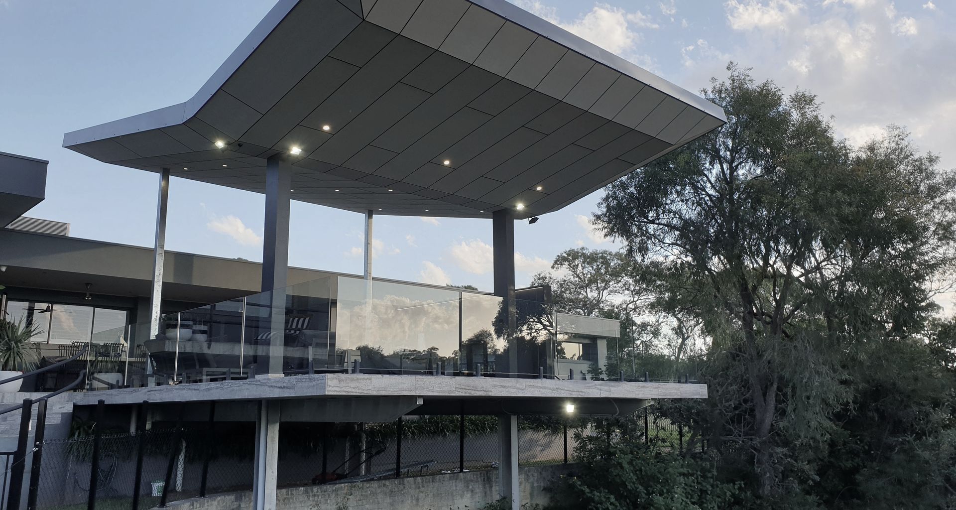 Annangrove Patio: Butterfly Roof Framing Mountainous Views banner