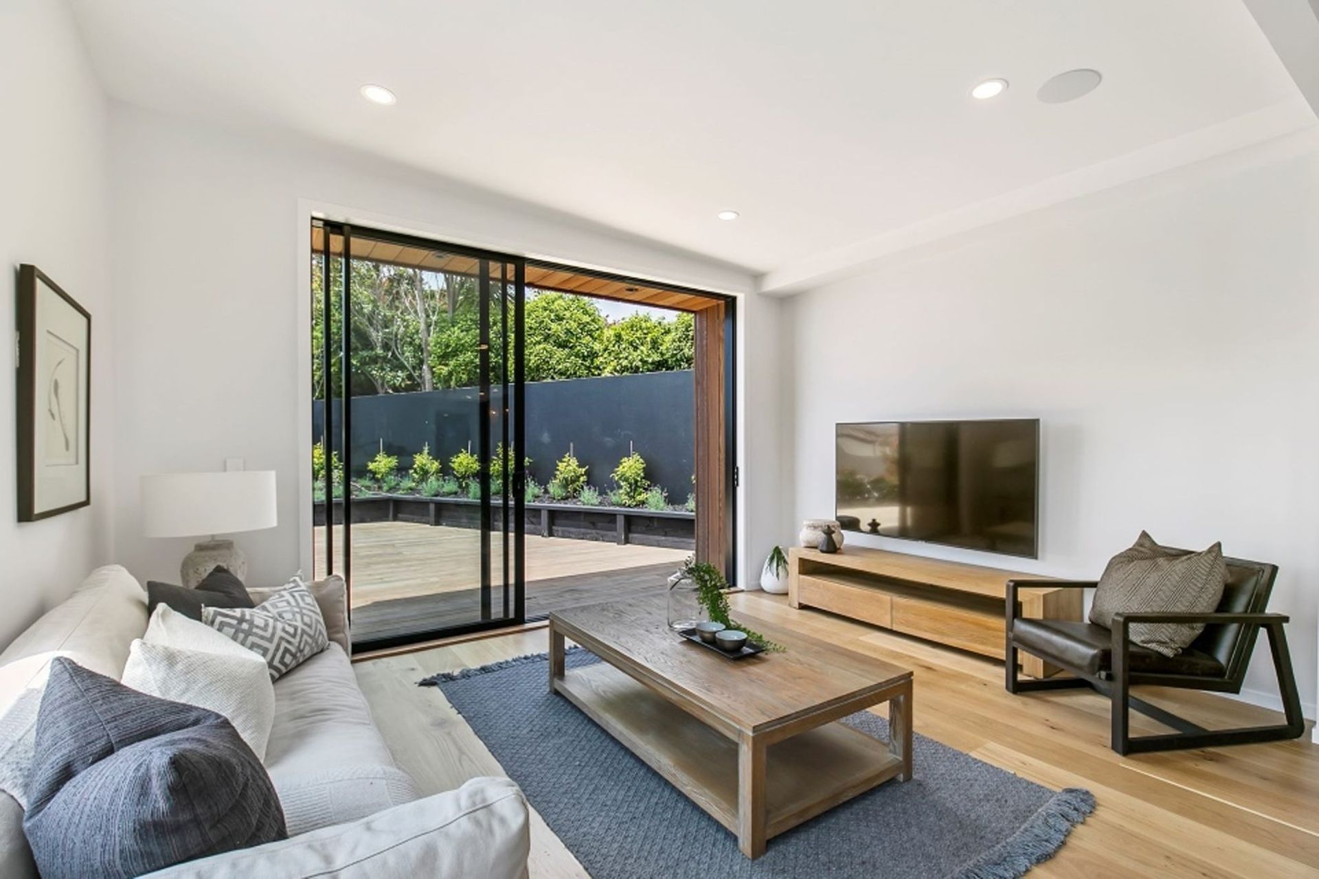 A small 'family room' space leads onto the side deck, allowing the owners to follow the sun throughout the day. This east-facing deck is ideal for morning coffee.