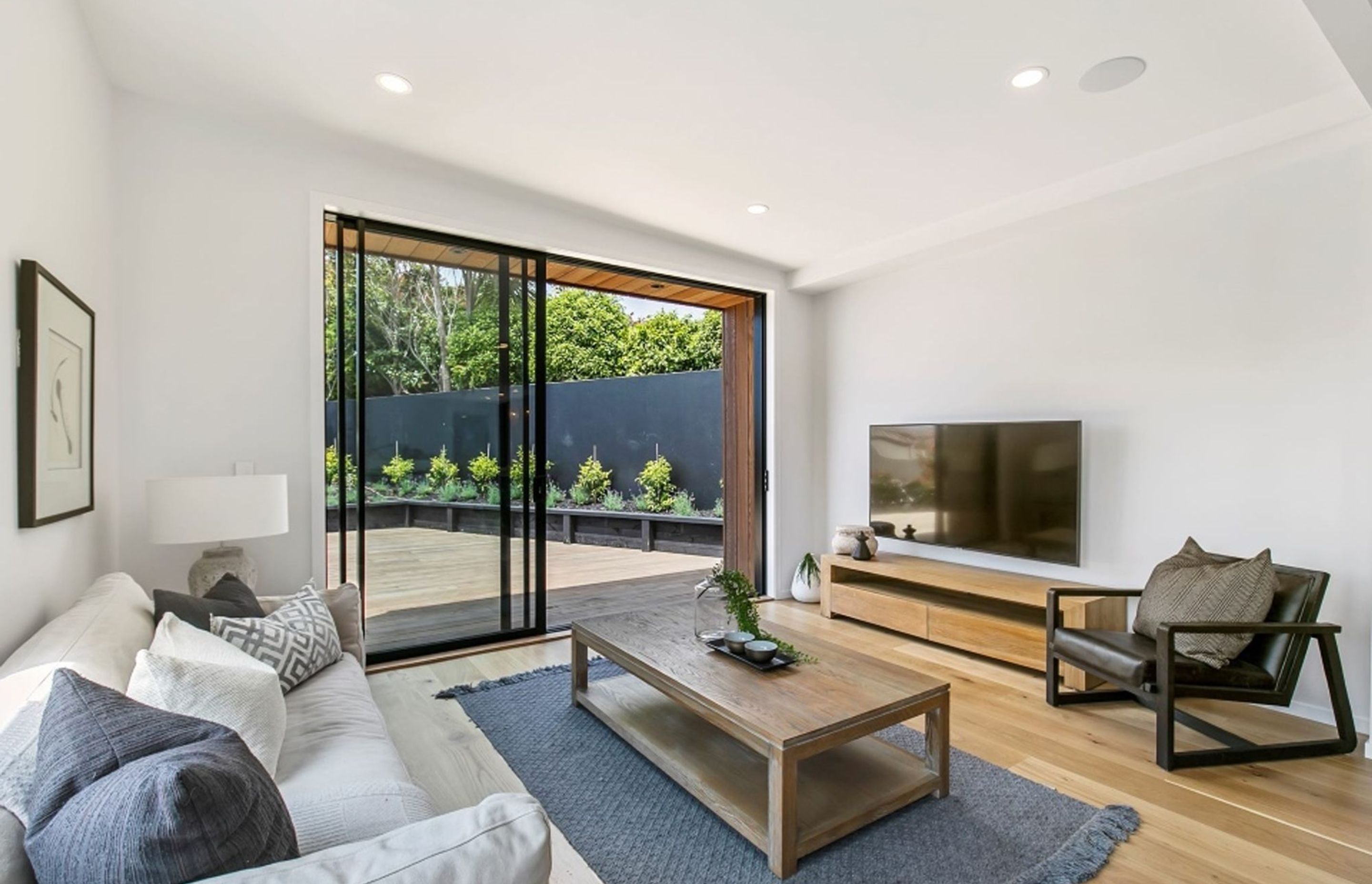 A small 'family room' space leads onto the side deck, allowing the owners to follow the sun throughout the day. This east-facing deck is ideal for morning coffee.