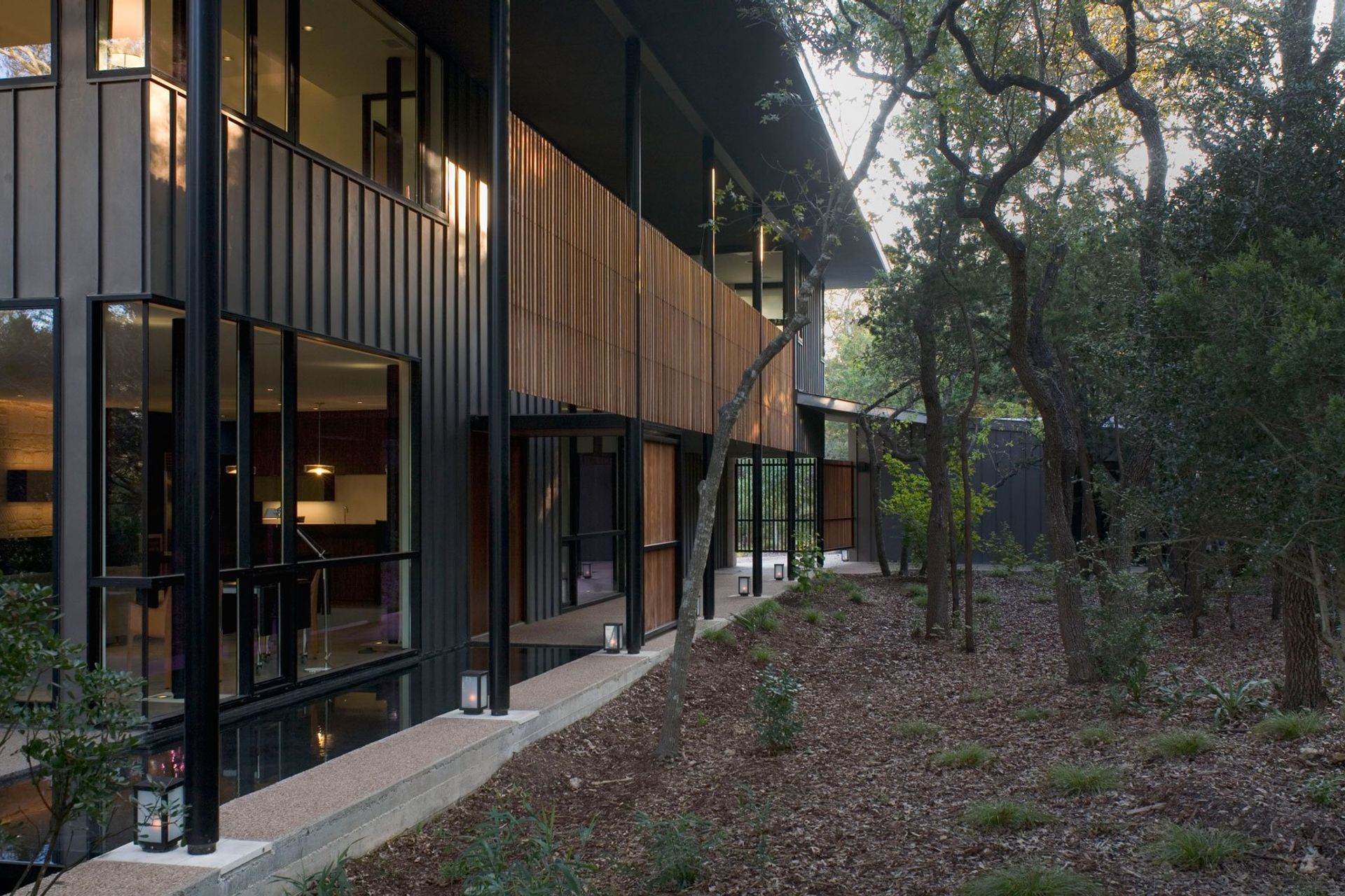 4HouseinTreesCuppettKilpatrickArchitectureandInteriorDesignaustin-tx-modern-residence-lap-pool-wood-door.jpg