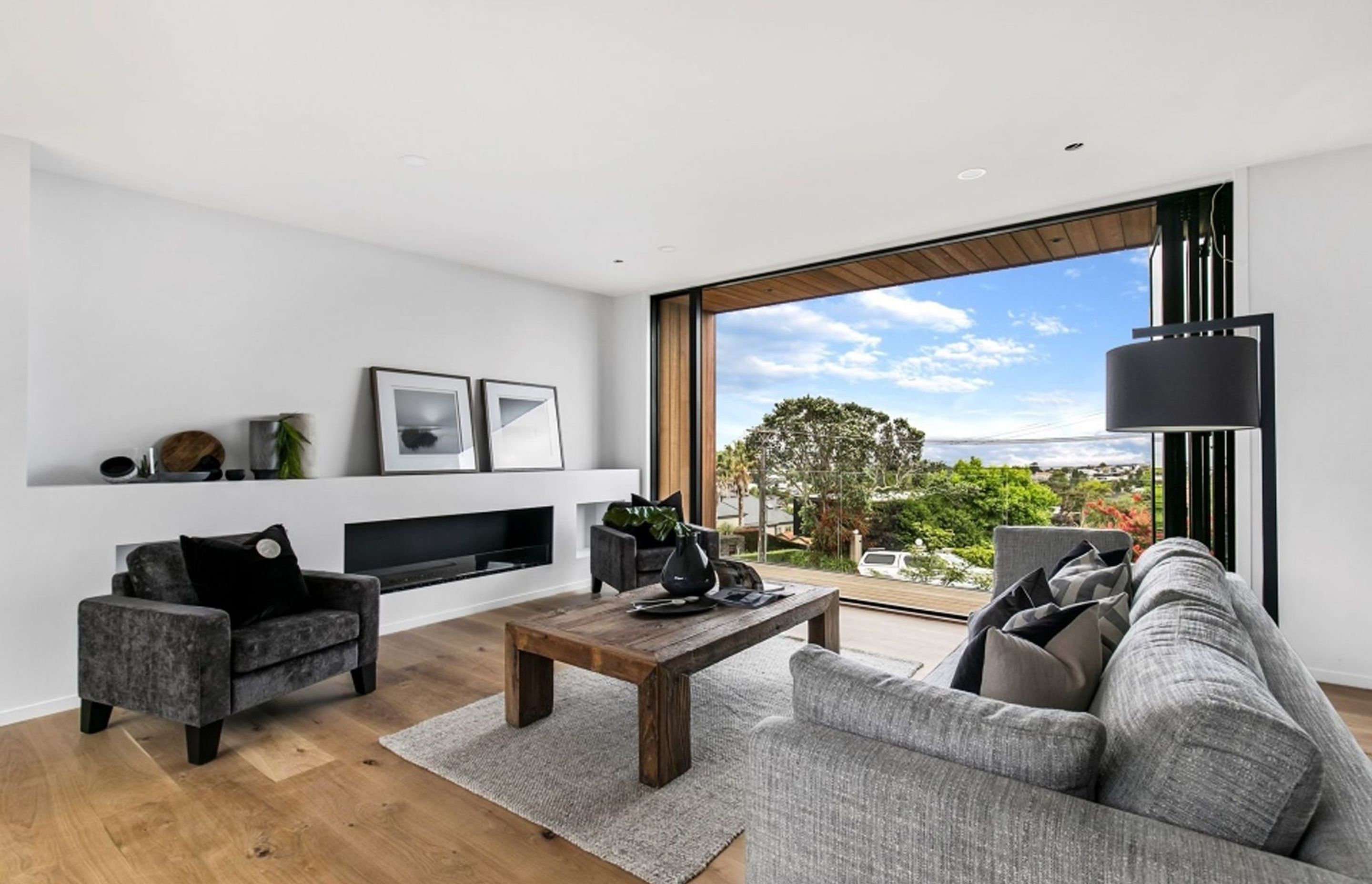 The north-facing balcony takes in the view over the neighbouring suburb and further afield towards Rangitoto.
