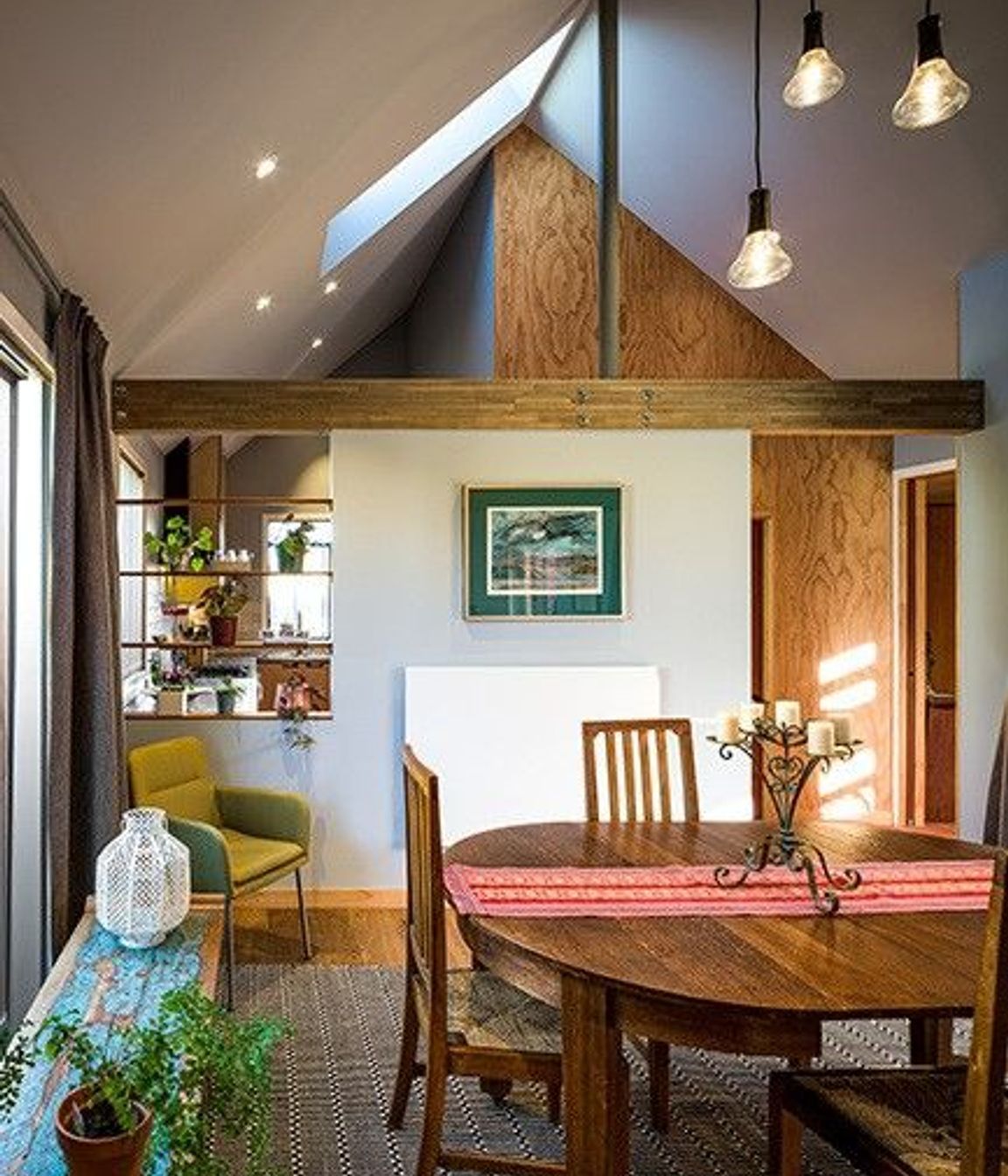 The predominantly open-plan scheme is divided into three distinct zones—lounge, dining and kitchen—through the use of partial walls. 