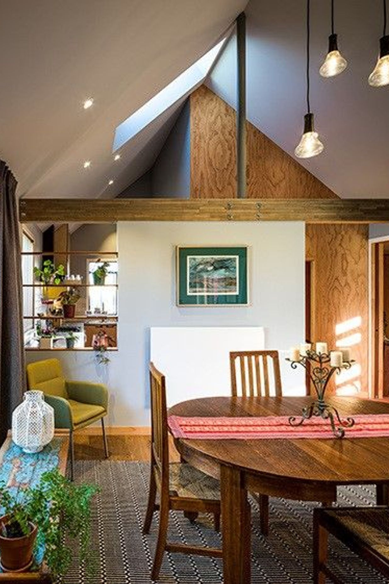 The predominantly open-plan scheme is divided into three distinct zones—lounge, dining and kitchen—through the use of partial walls.