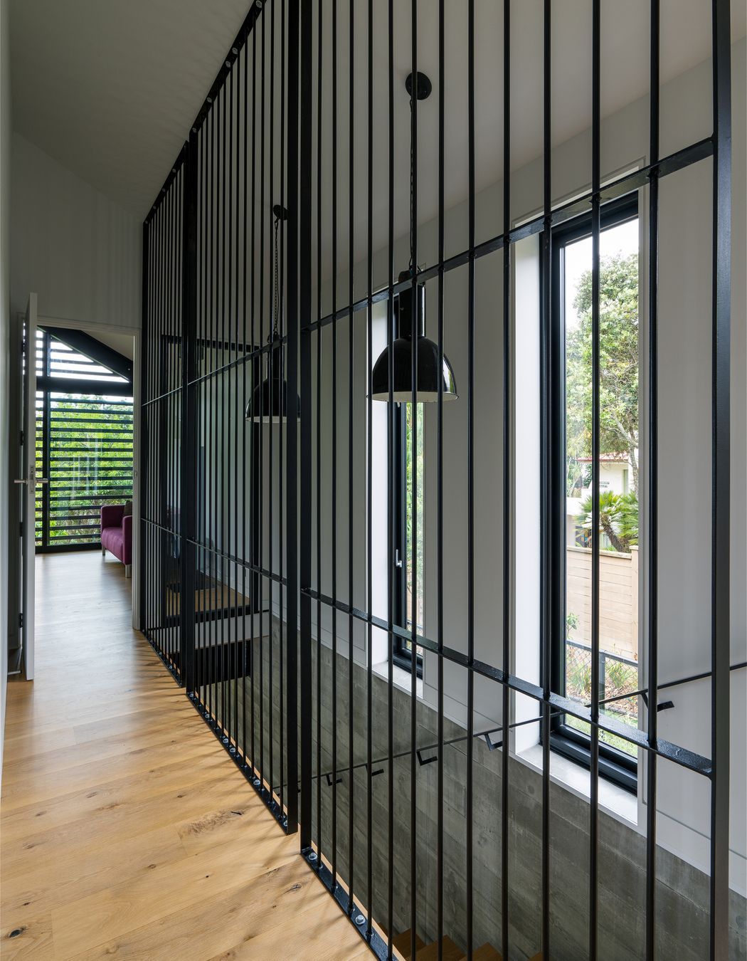 Clive wanted to separate the stairwell but not put in a solid wall. He considered black netting before trying the metal rods, framing them into panels to stop them flexing. “It was an aesthetic that just developed, and met my design idea to keep the hallway as open as possible.”