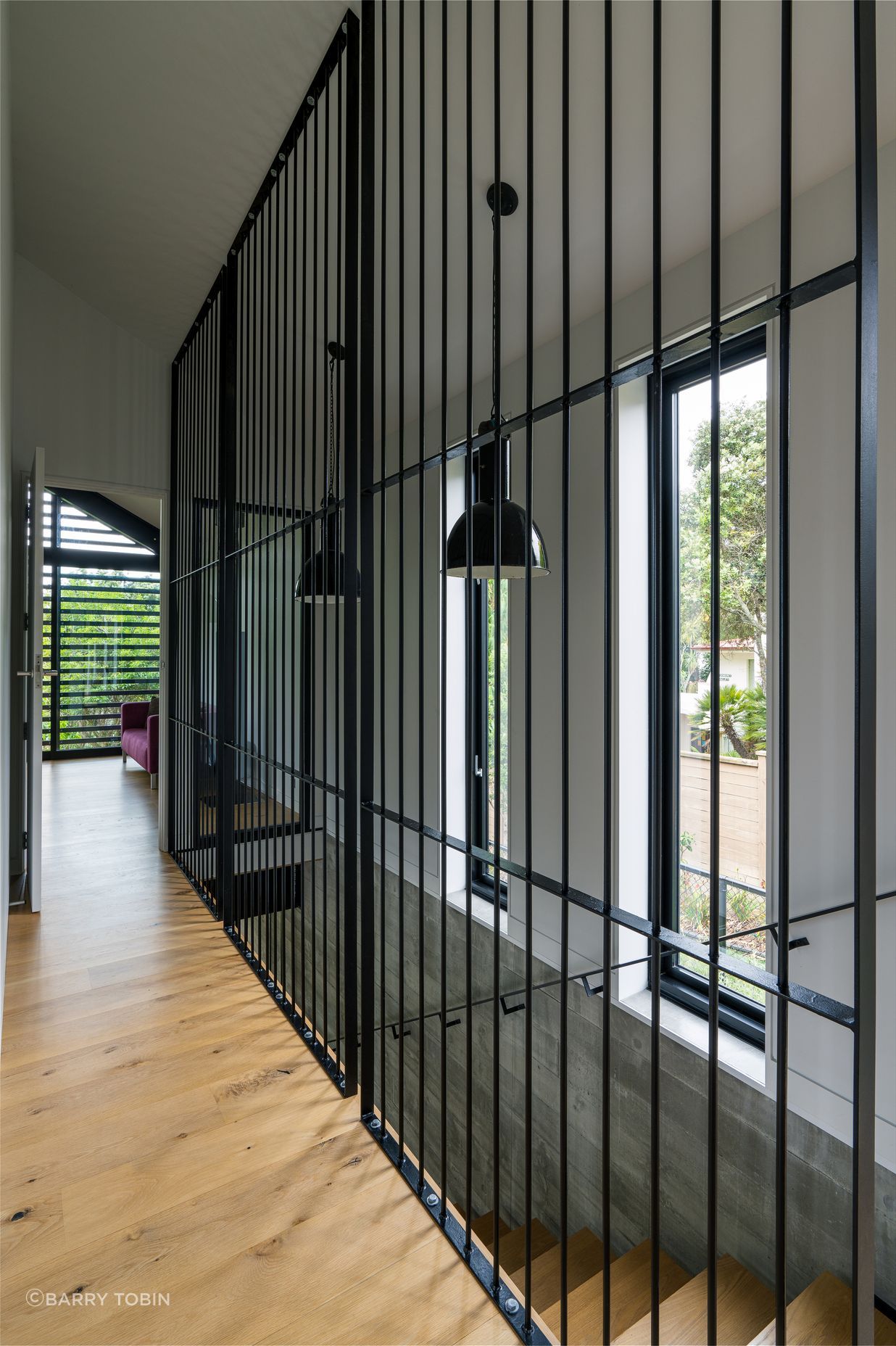 Clive wanted to separate the stairwell but not put in a solid wall. He considered black netting before trying the metal rods, framing them into panels to stop them flexing. “It was an aesthetic that just developed, and met my design idea to keep the hallway as open as possible.”