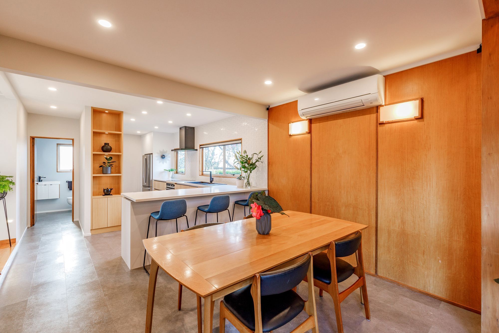Knocking down walls between the hallway, kitchen, and dining area created a spacious and inviting atmosphere.