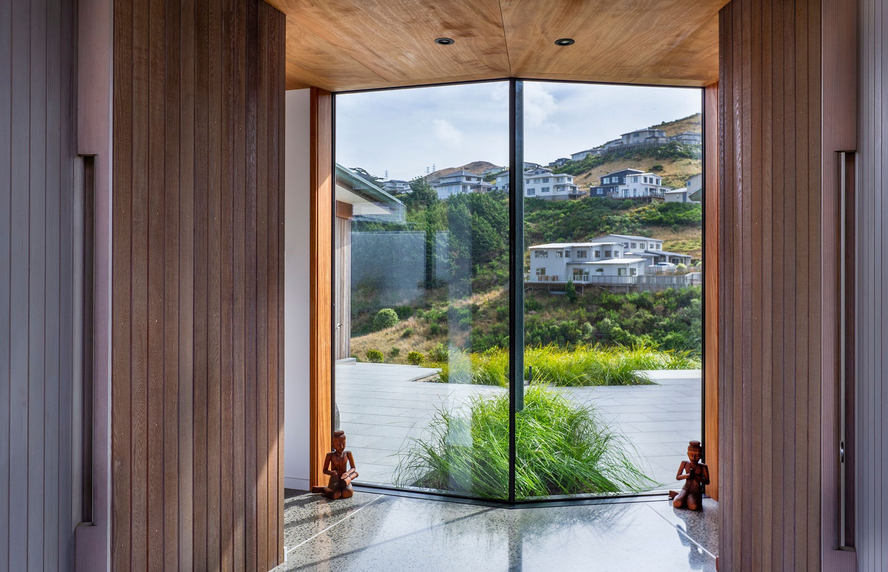 The west-facing site sits between the road and a valley reserve, which has been planted in native planting and also contains the beginnings of the Porirua Stream.