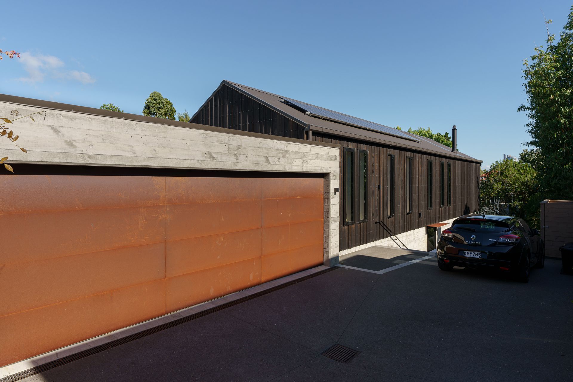 Smaller windows on the driveway side of the house offer improved privacy. “The garage is half full of bikes, skis and sports gear,” says Clive.
