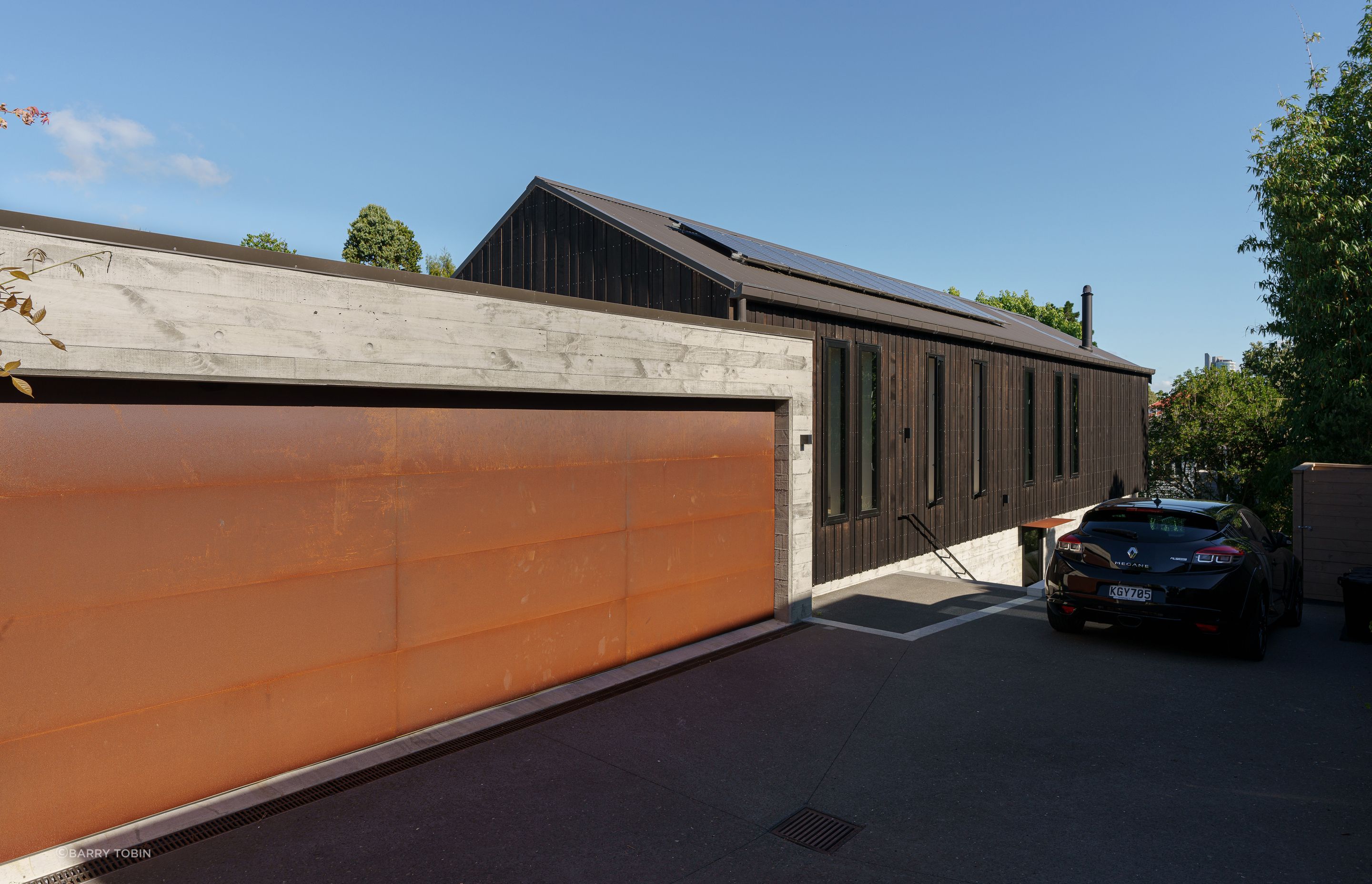 Smaller windows on the driveway side of the house offer improved privacy. “The garage is half full of bikes, skis and sports gear,” says Clive.